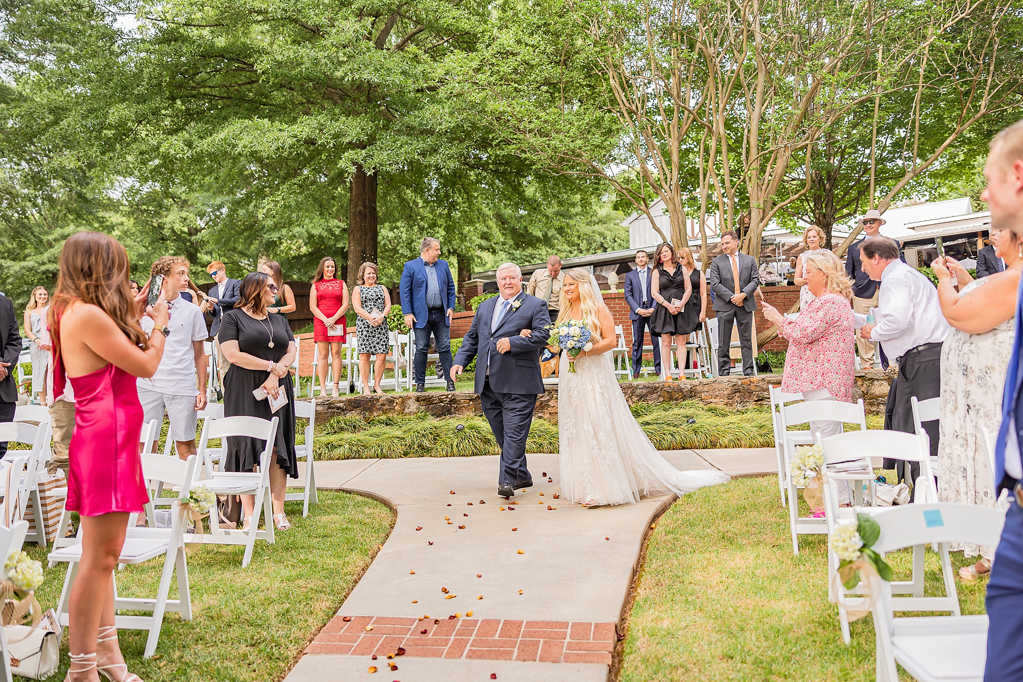 bride and dad walk down aisle during GA wedding ceremony