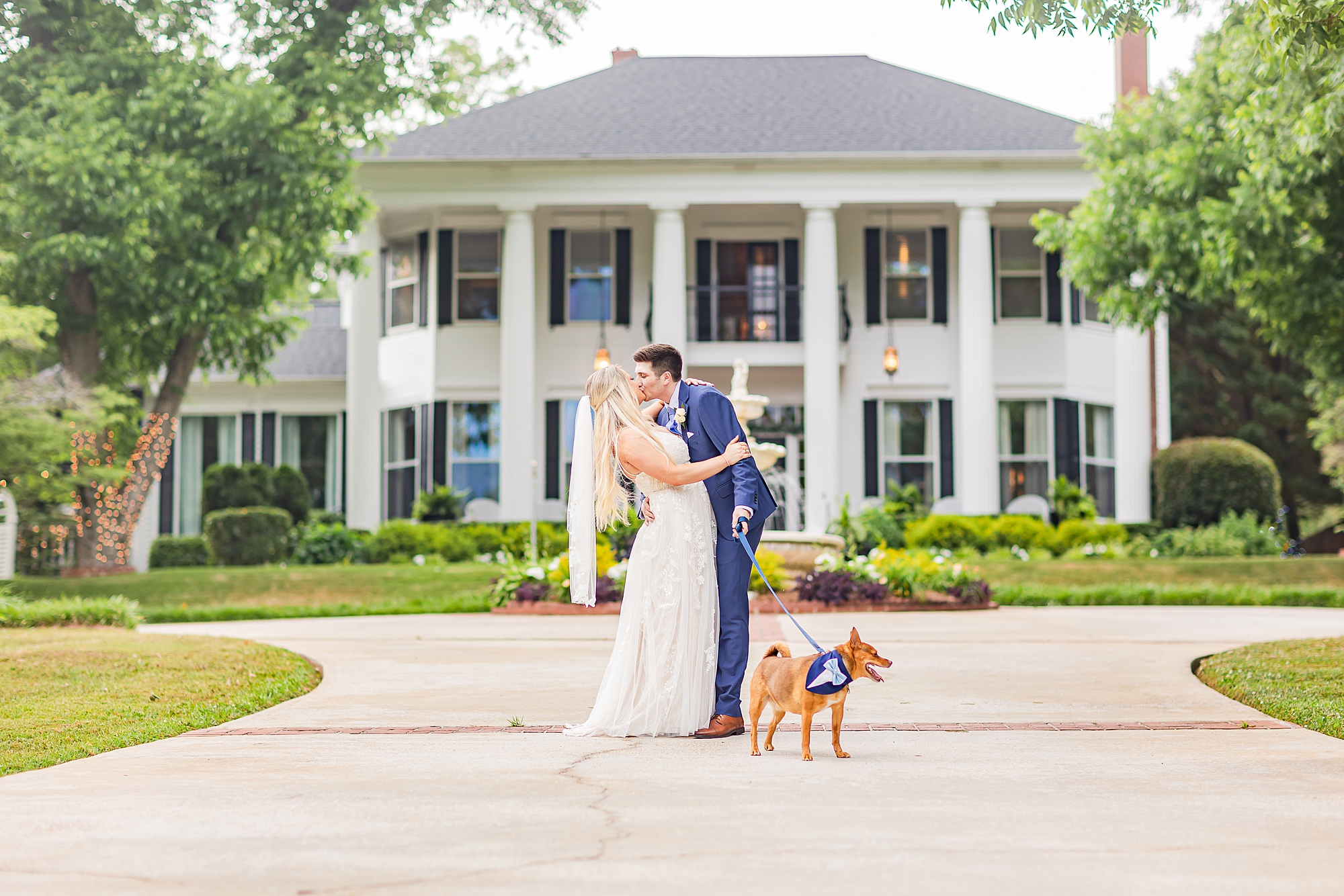 spring wedding portraits on driveway outside the Victoria Belle Mansion
