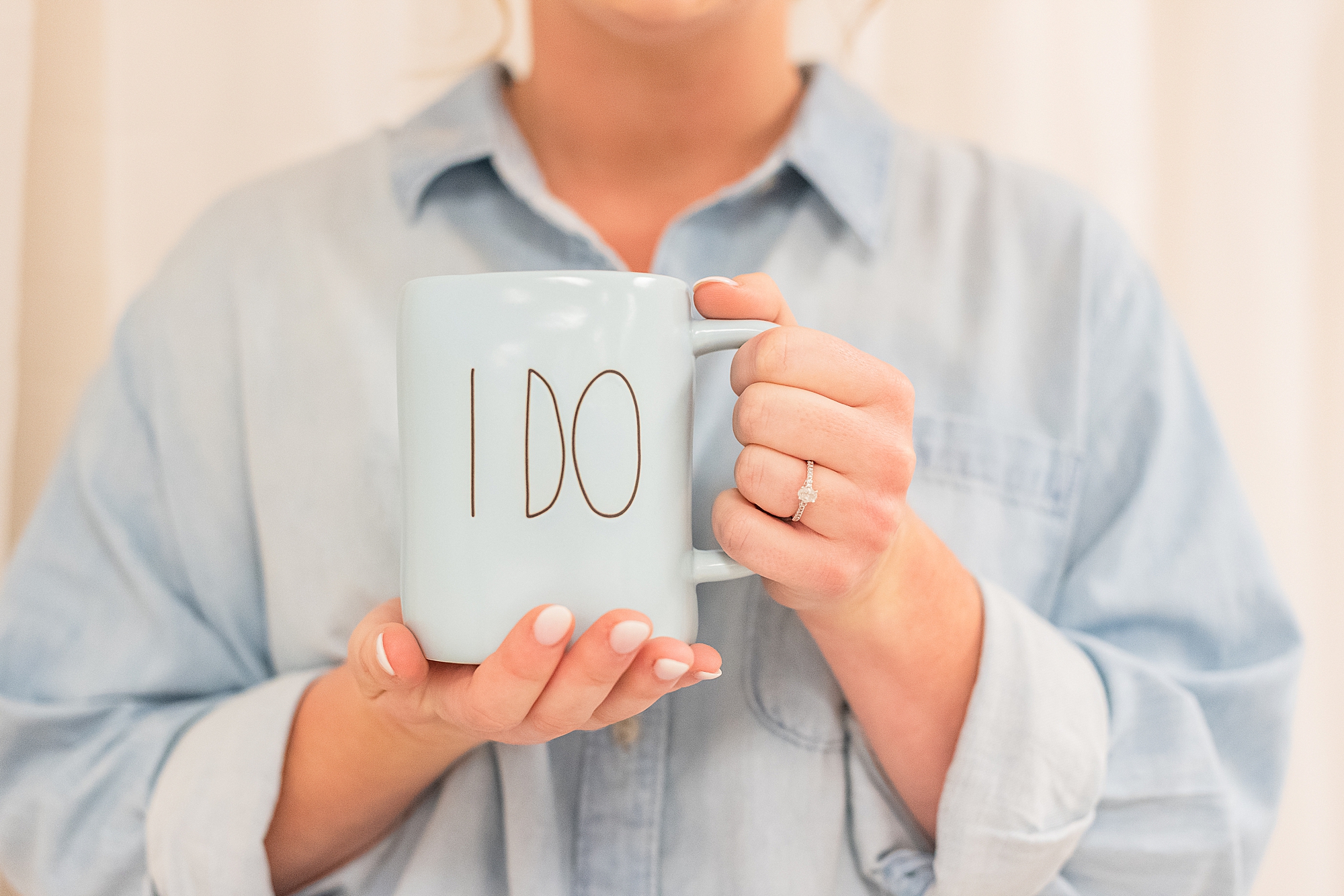 bride holds "I Do" mug
