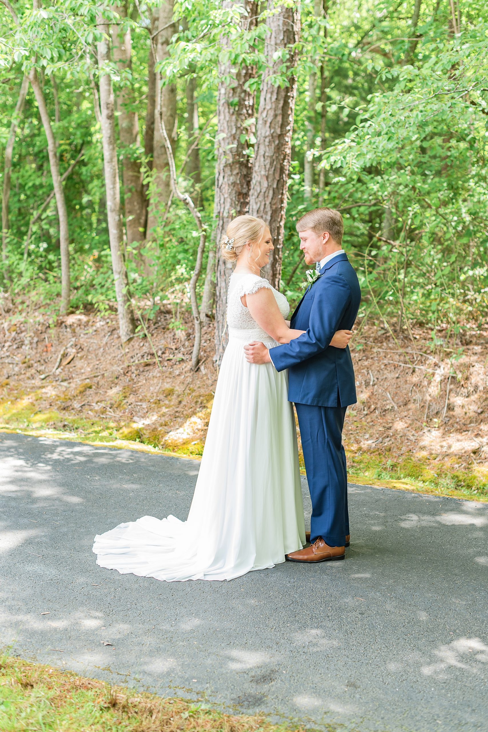 bride and groom hug along pathway outside Blairsville GA church