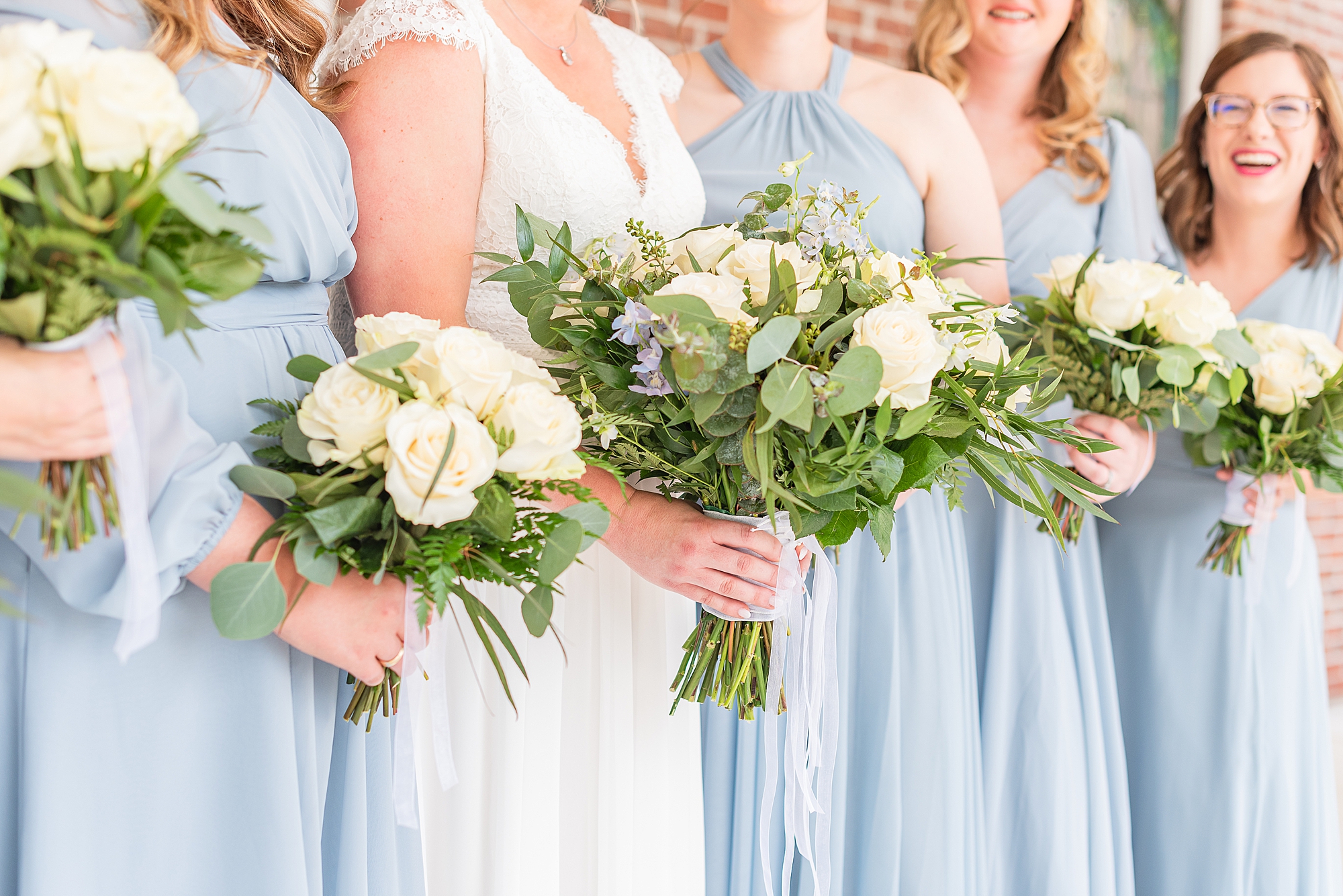 bridesmaids in light blue gowns hold yellow flowers for Blairsville GA wedding
