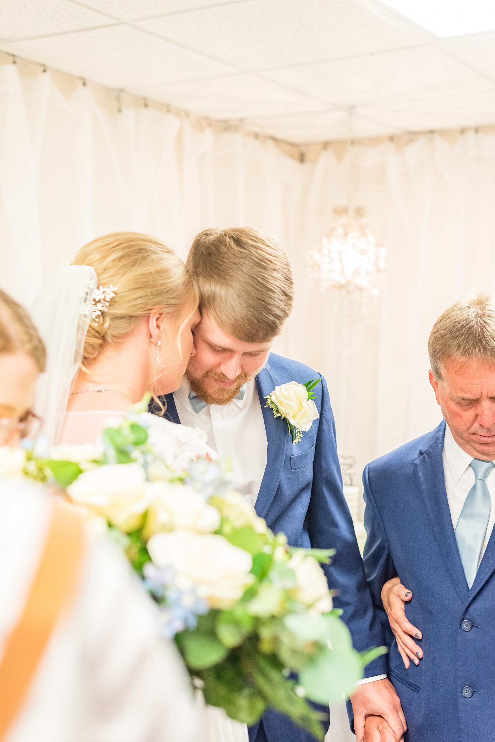 bride leans head into groom's cheek during reception