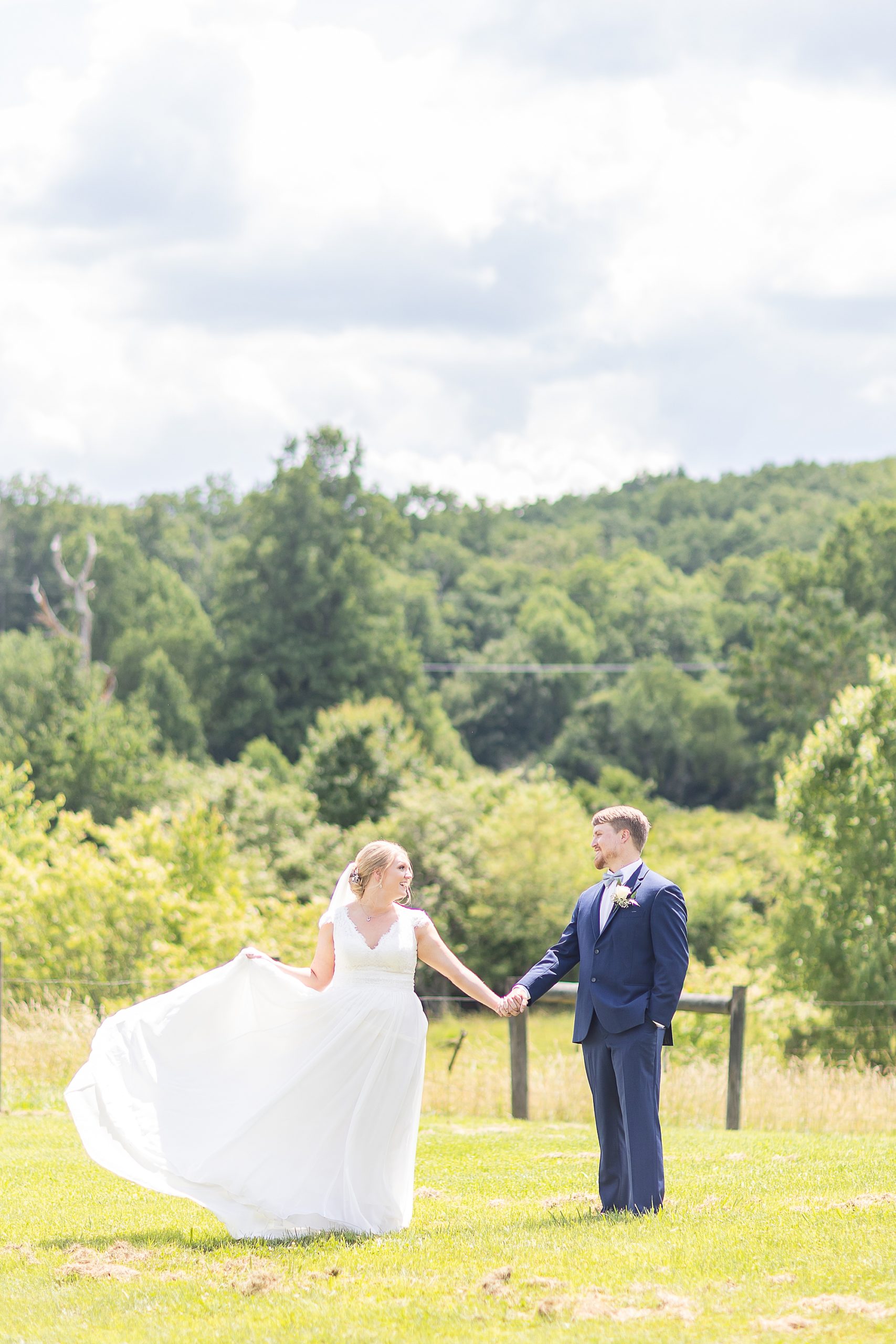 bride and groom hold hands during Blairsville GA wedding portraits 