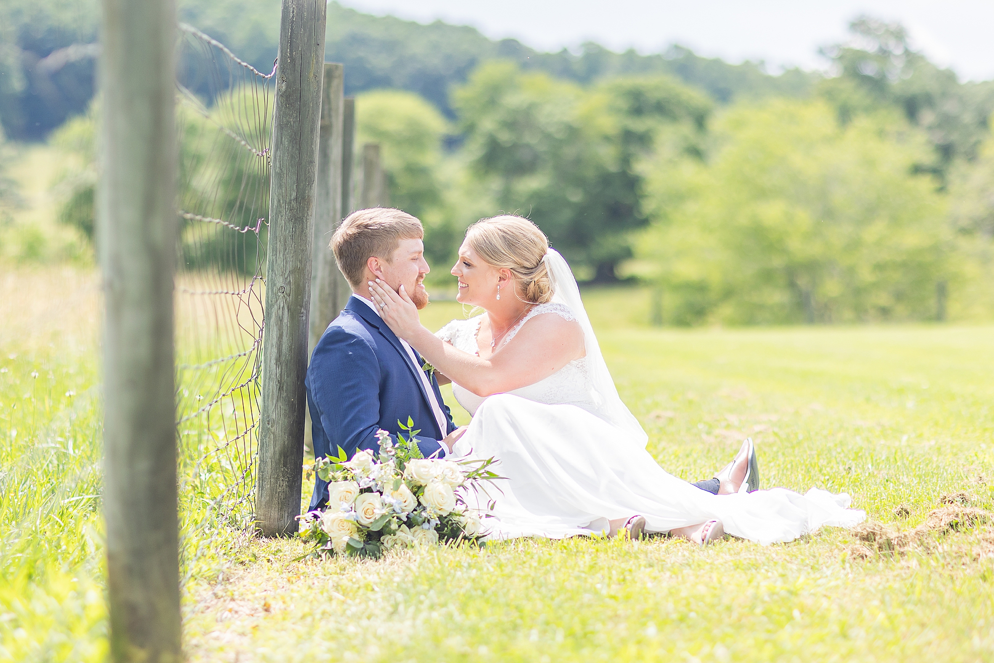 bride and groom sit together by fence post in Blairsville GA