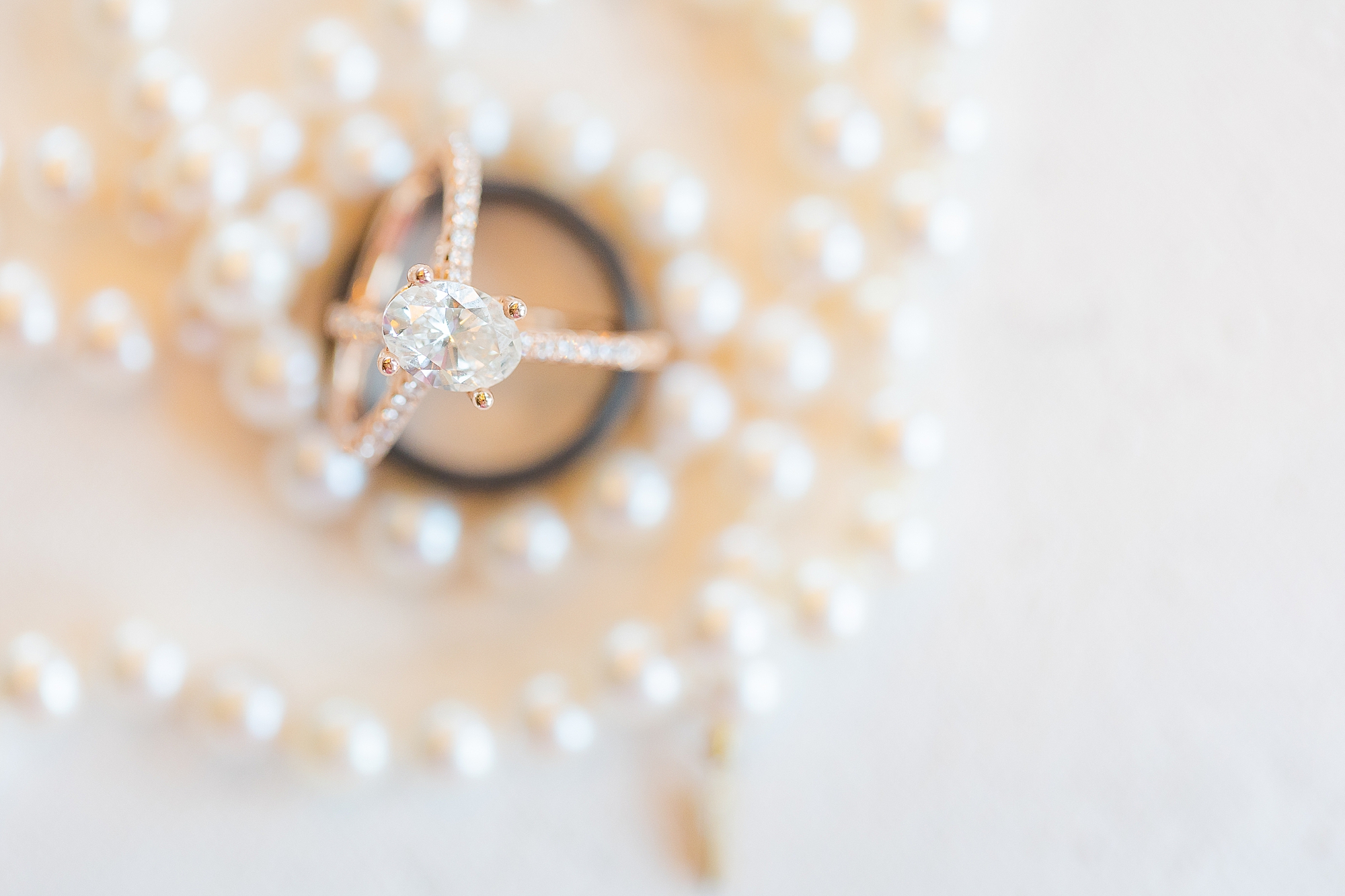 bride's rings rest among pearls for OBX wedding