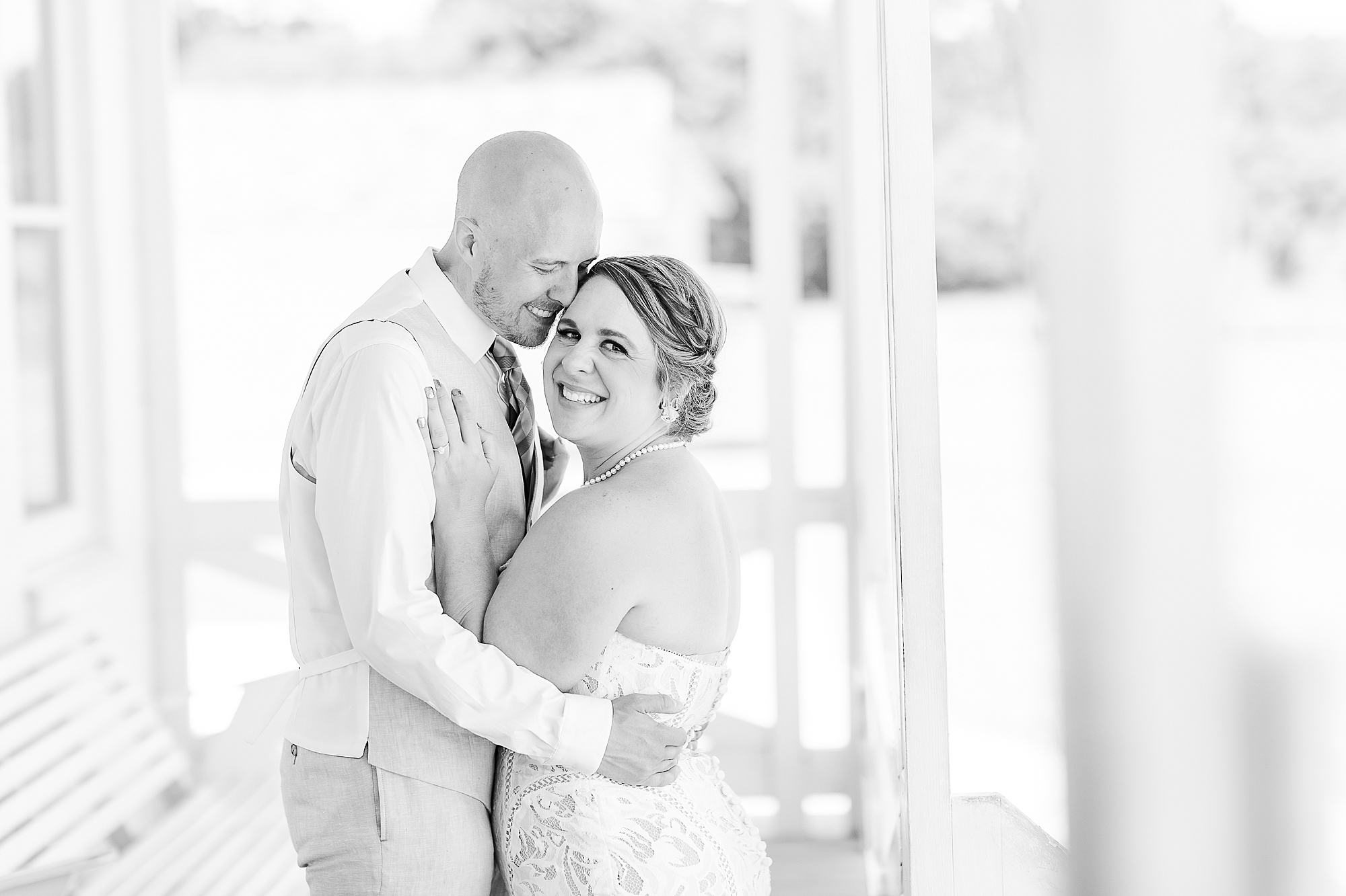 groom leans into bride's cheek during portraits by Bodie Lighthouse 