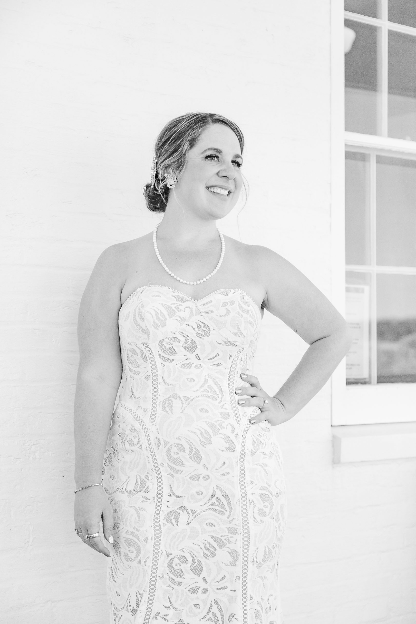 bride stands with hand on hip during portraits for OBX wedding