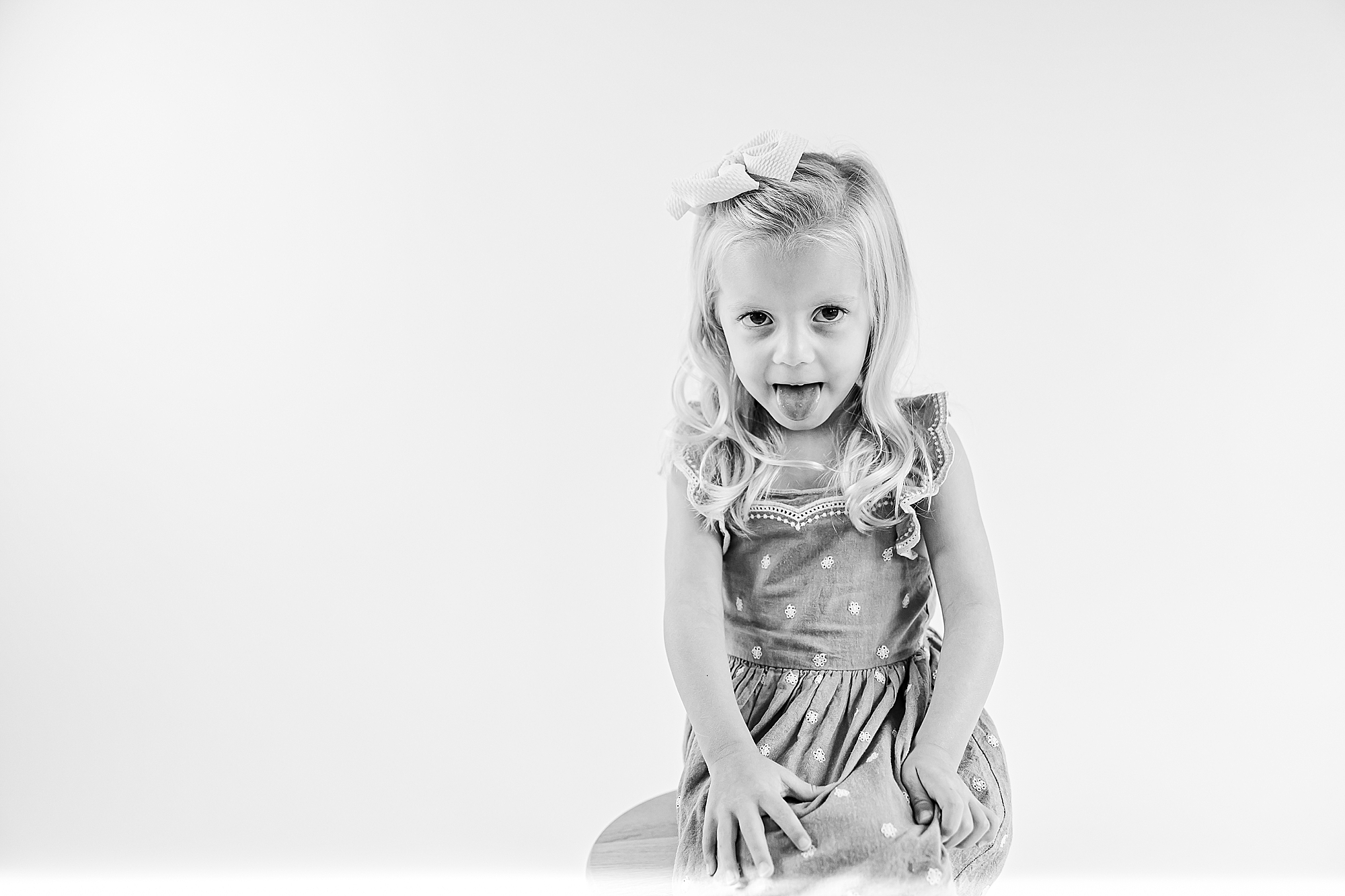 light haired girl poses in summer dress during Charlotte Personality Portraits
