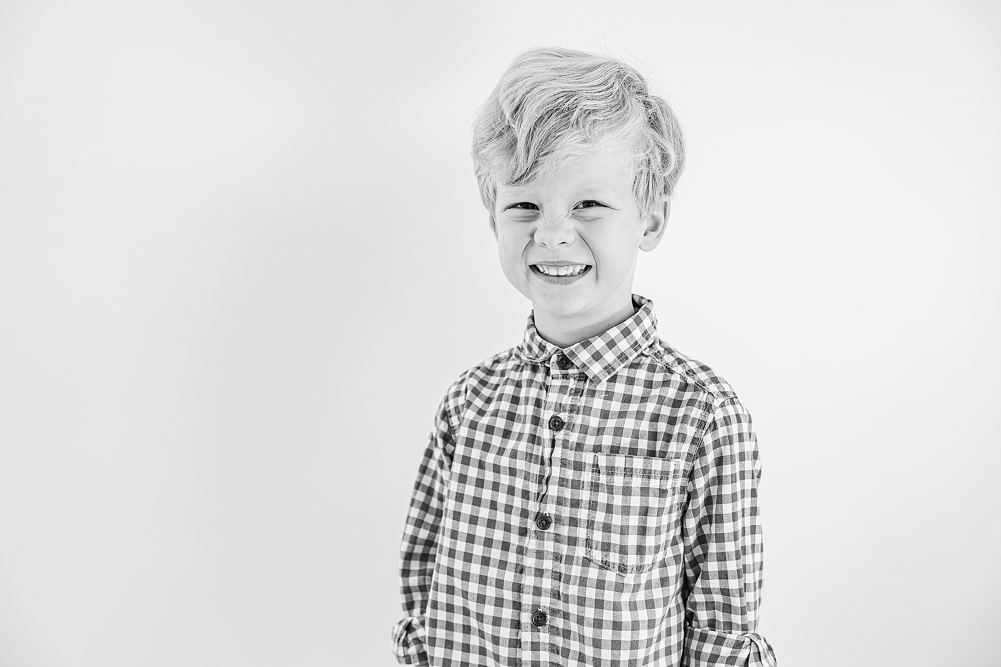 boy grins laughing during Charlotte Personality Portraits