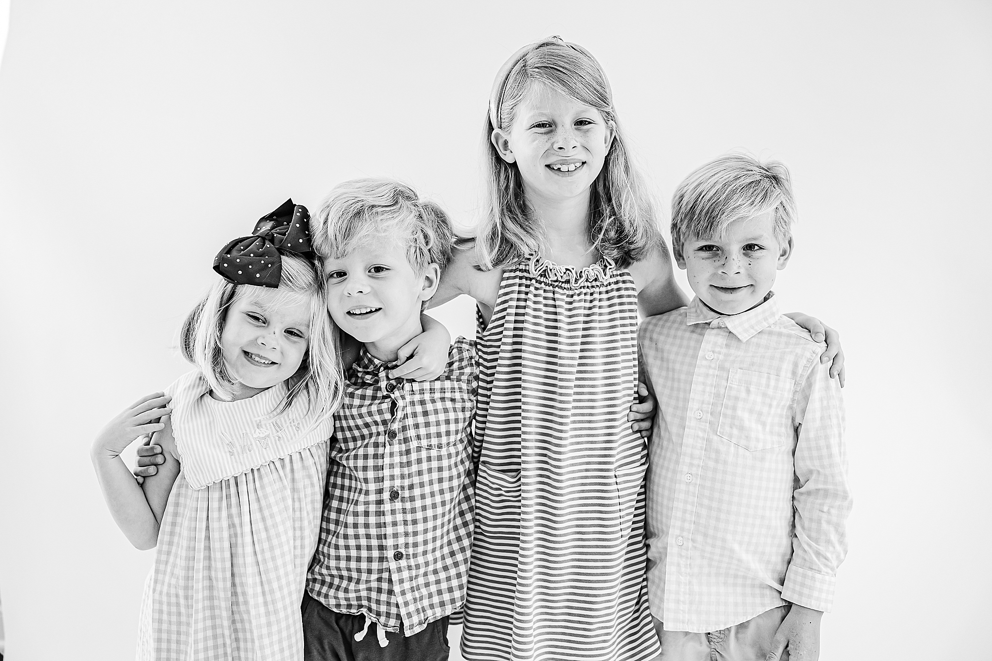 four siblings hug during Charlotte personality portraits