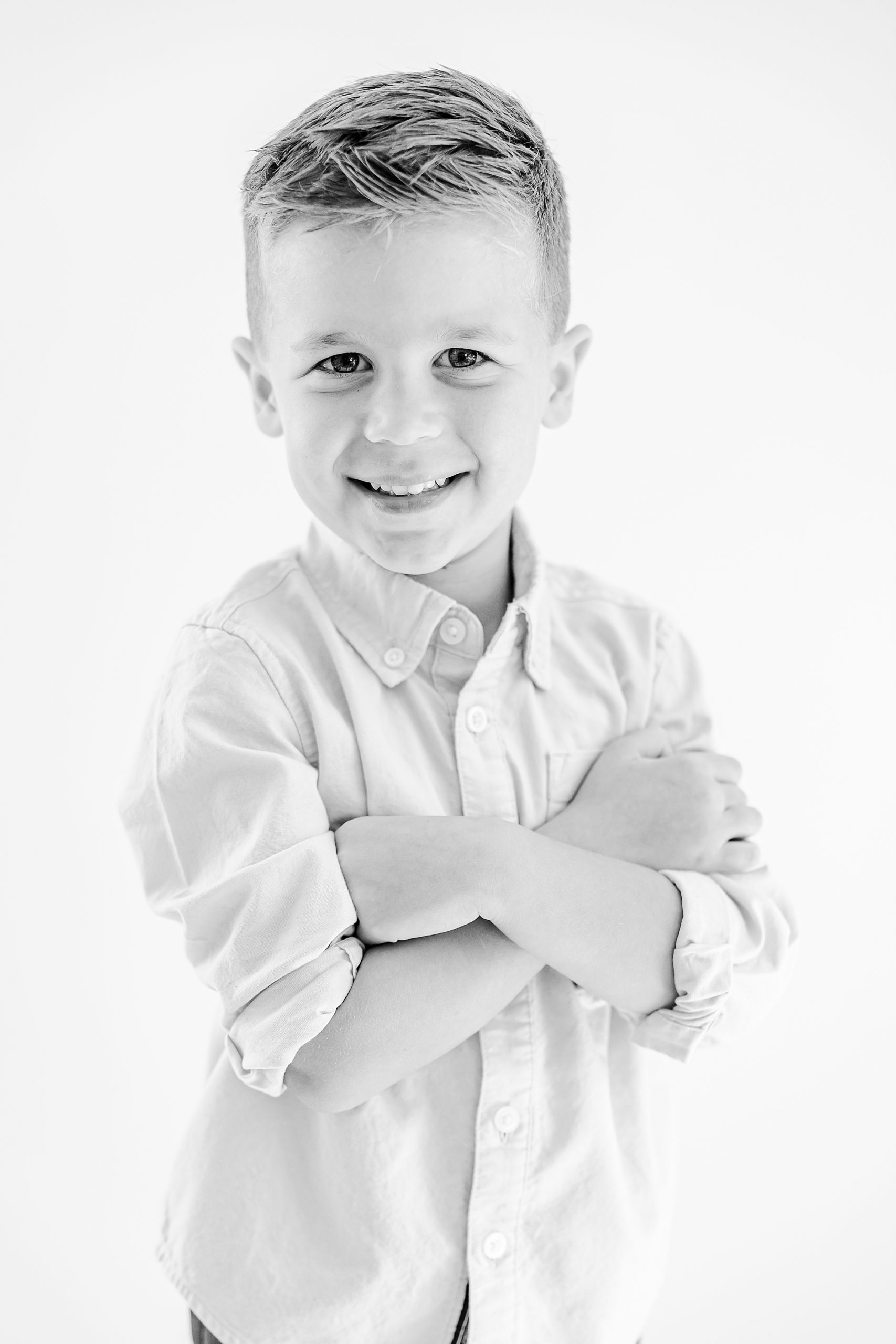 boy crosses his arms during personality portraits in home studio
