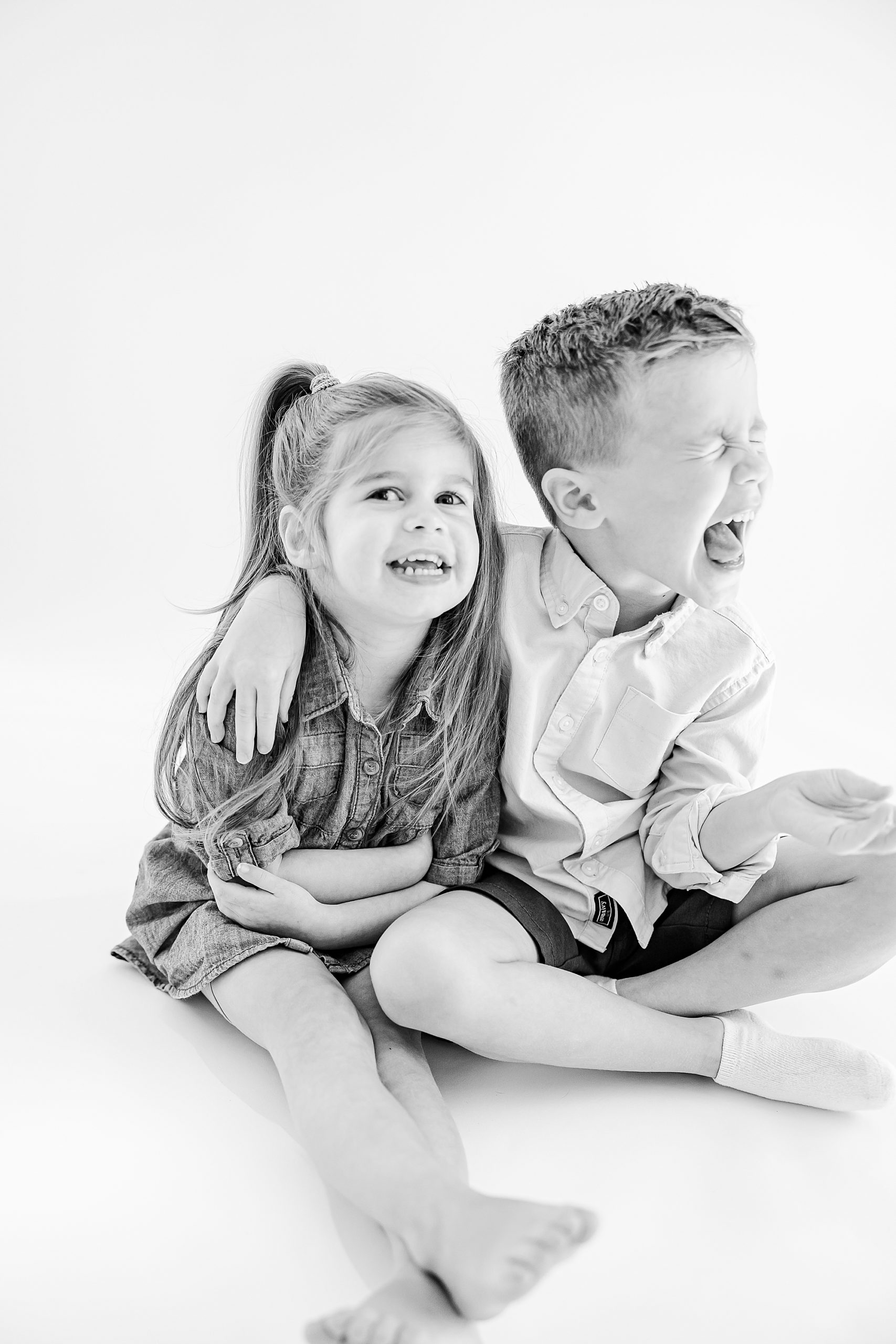 siblings laugh together during Charlotte personality portraits