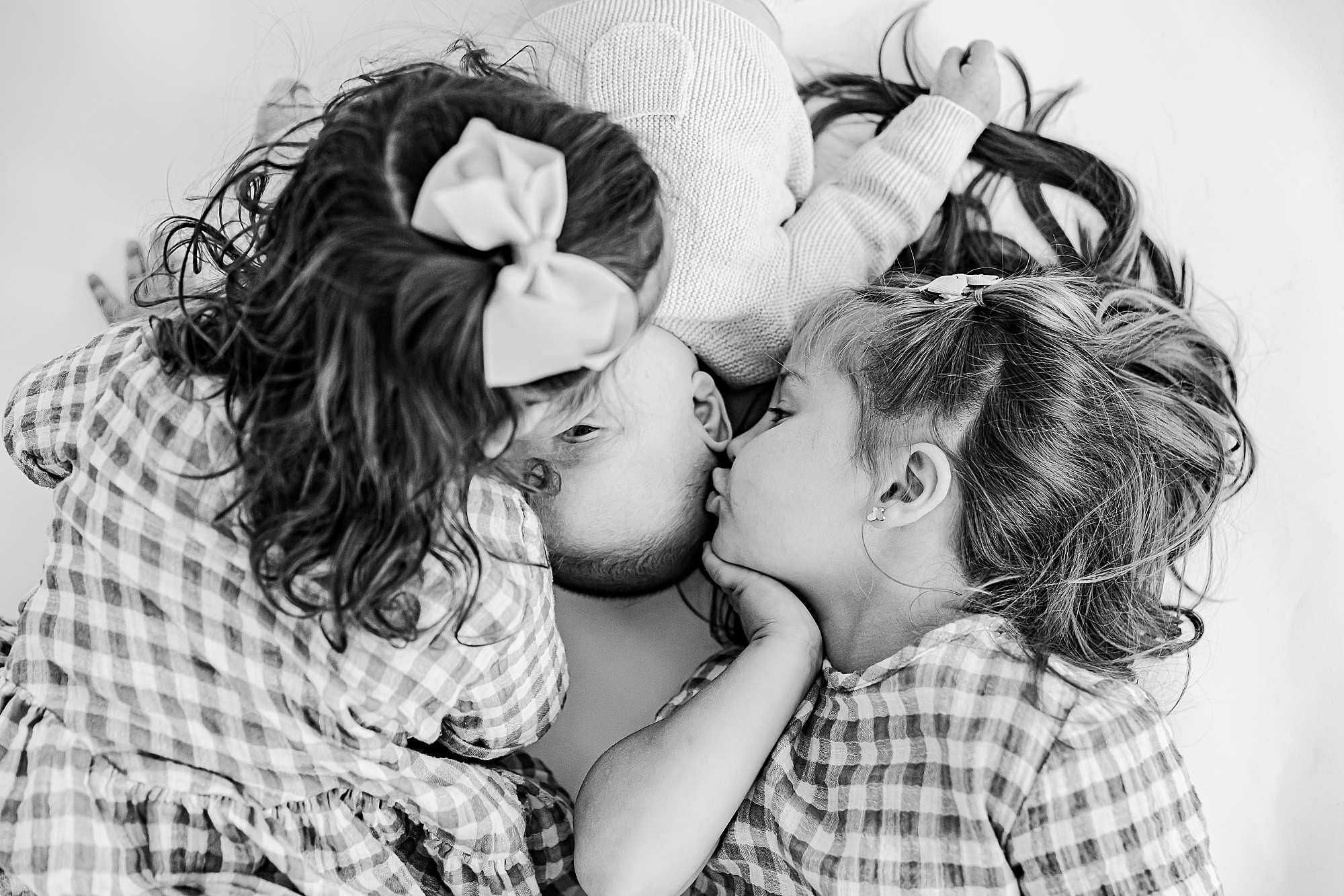 girls kiss sister during personality portraits in studio