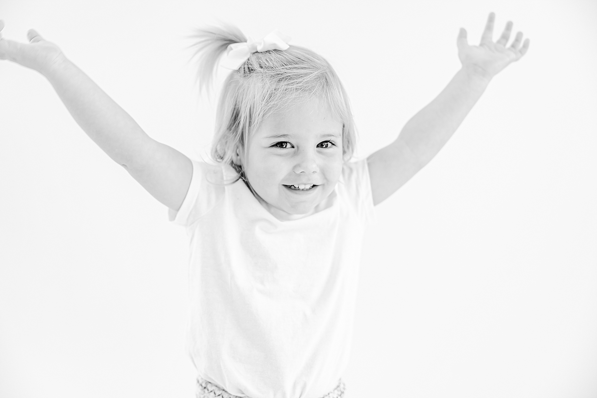 girl throws hands in the air during studio personality portraits