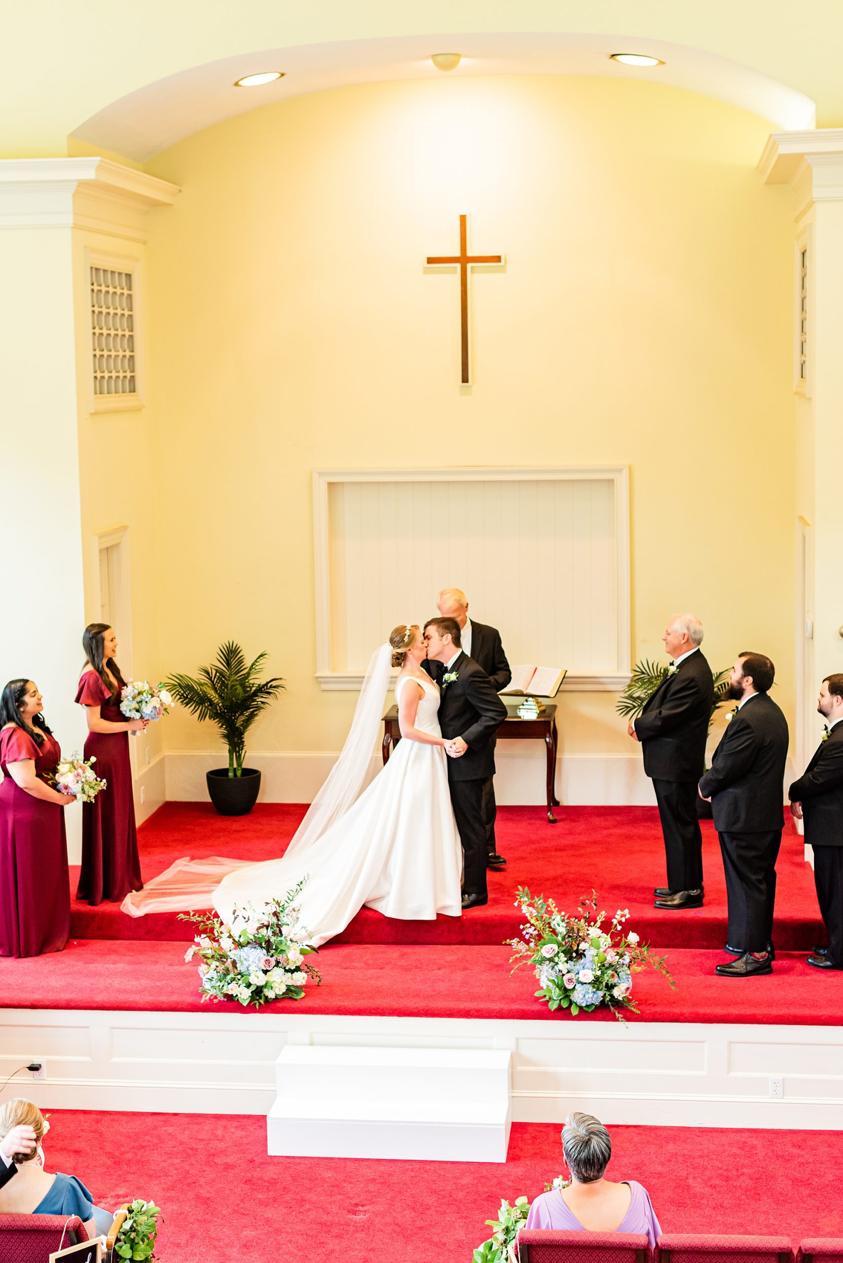 bride and groom kiss during ceremony at College Park Baptist Church