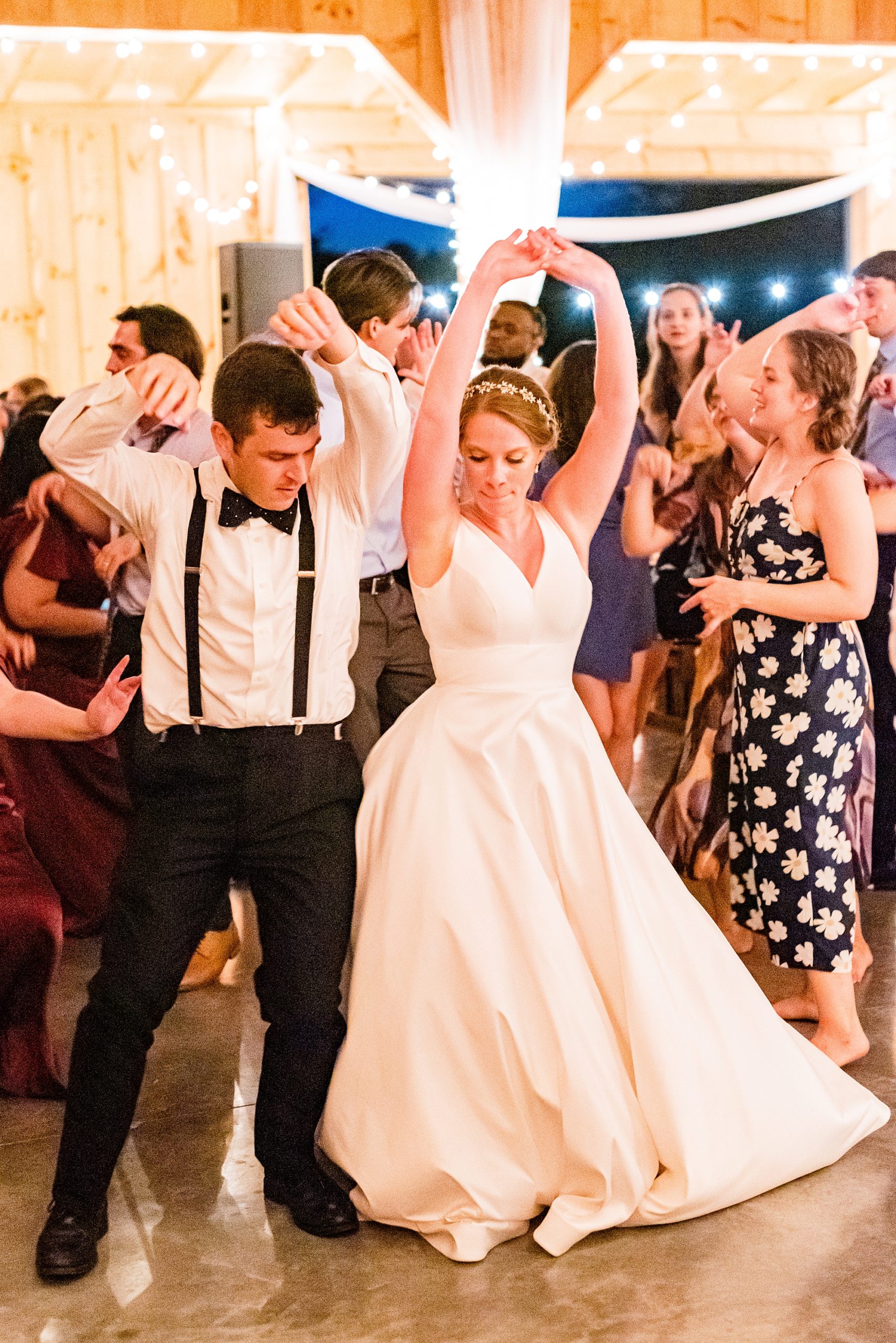 bride and groom dance bumping hips at reception at Old Homeplace Vineyard