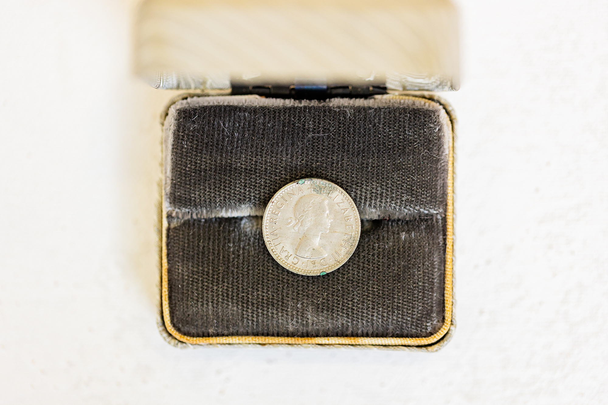 coin sits in grey box before NC wedding