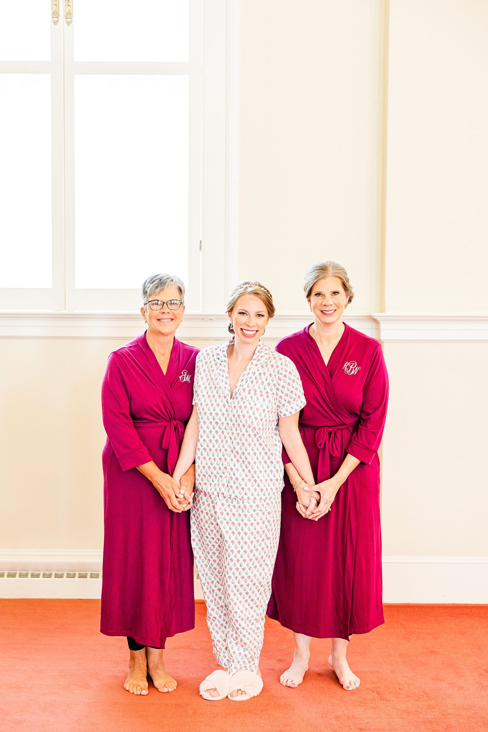 bride stands with mother and grandmother before NC wedding 