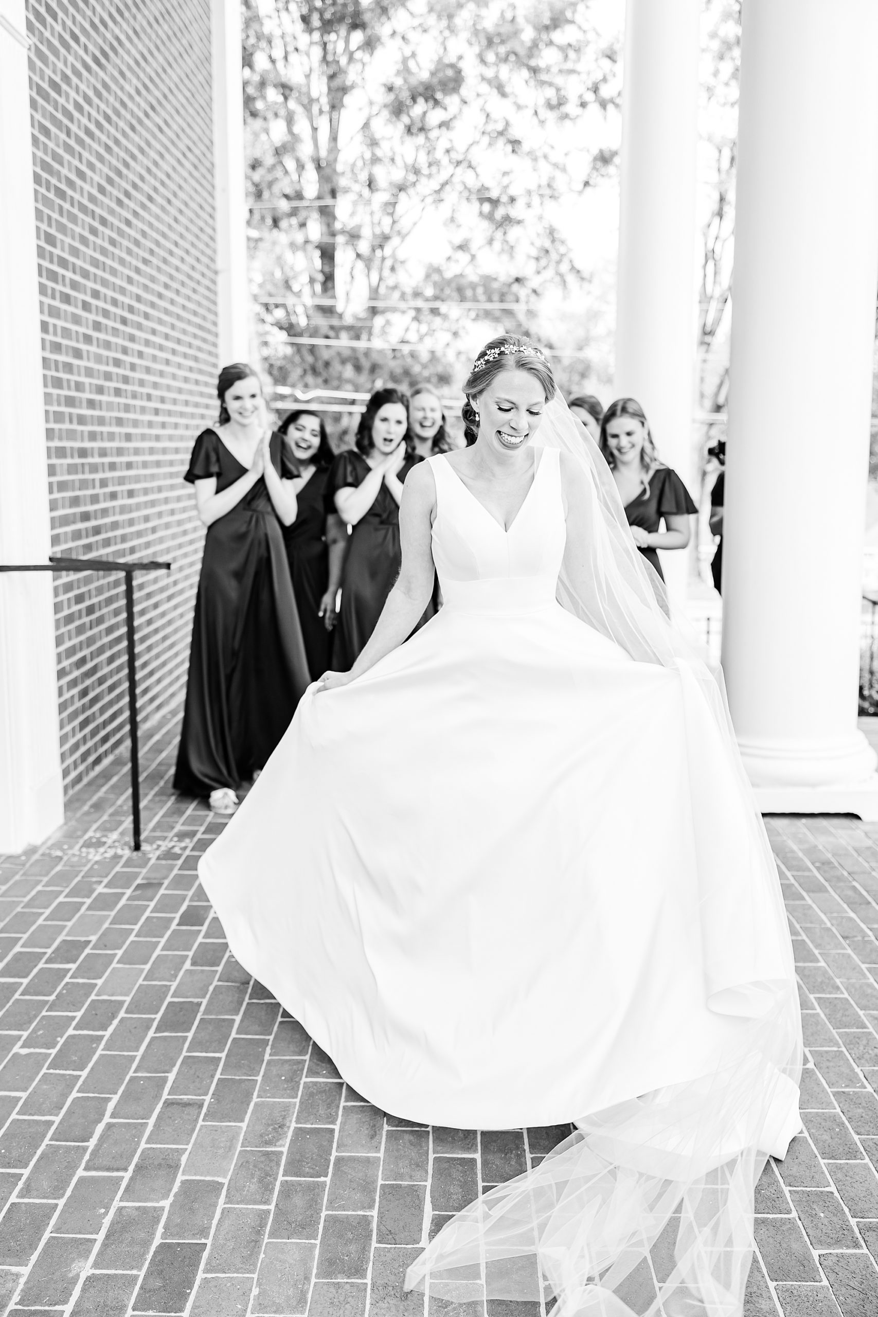 bride twirls showing off wedding dress on porch of College Park Baptist Church