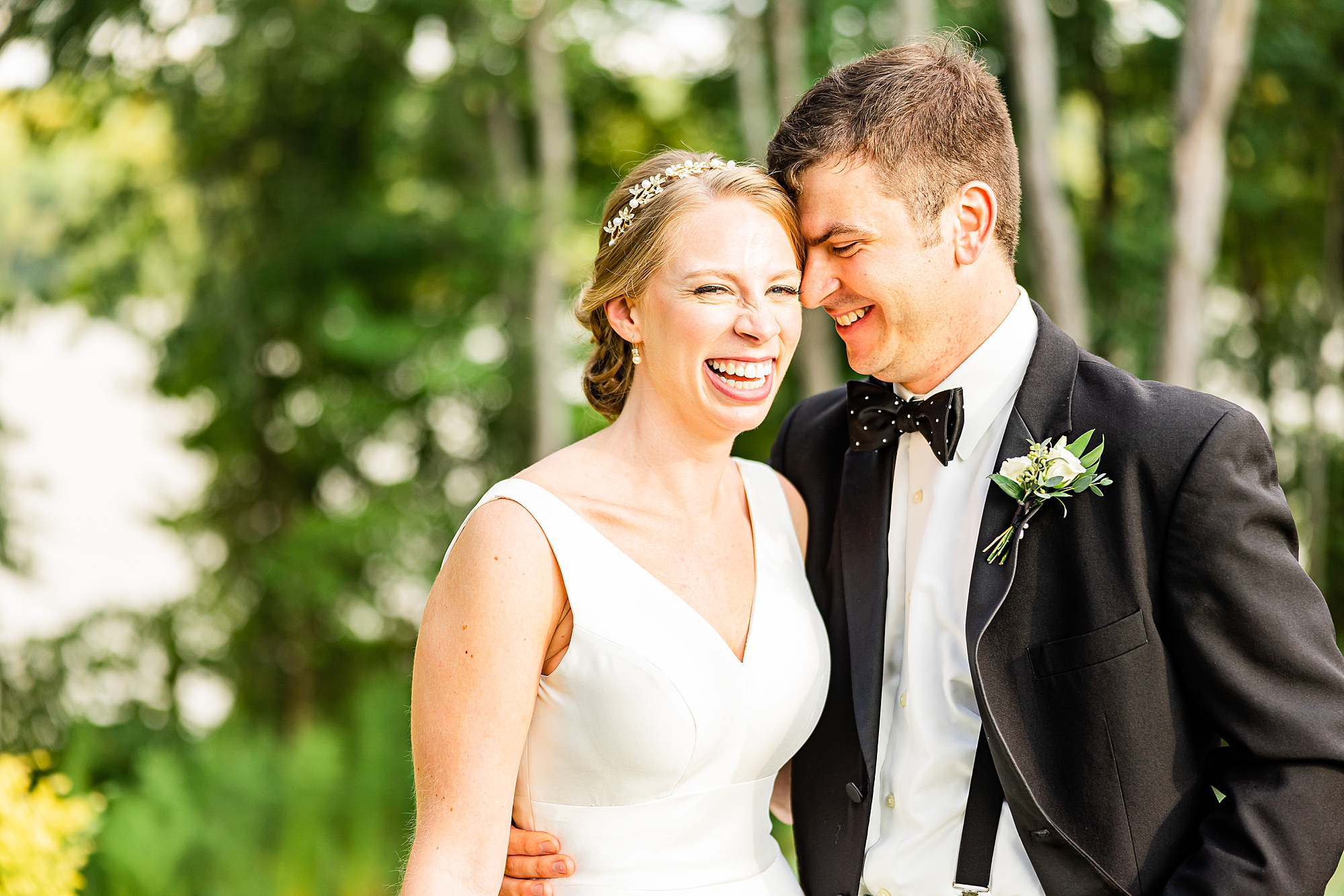 groom laughs with bride outside Old Homeplace Vineyard