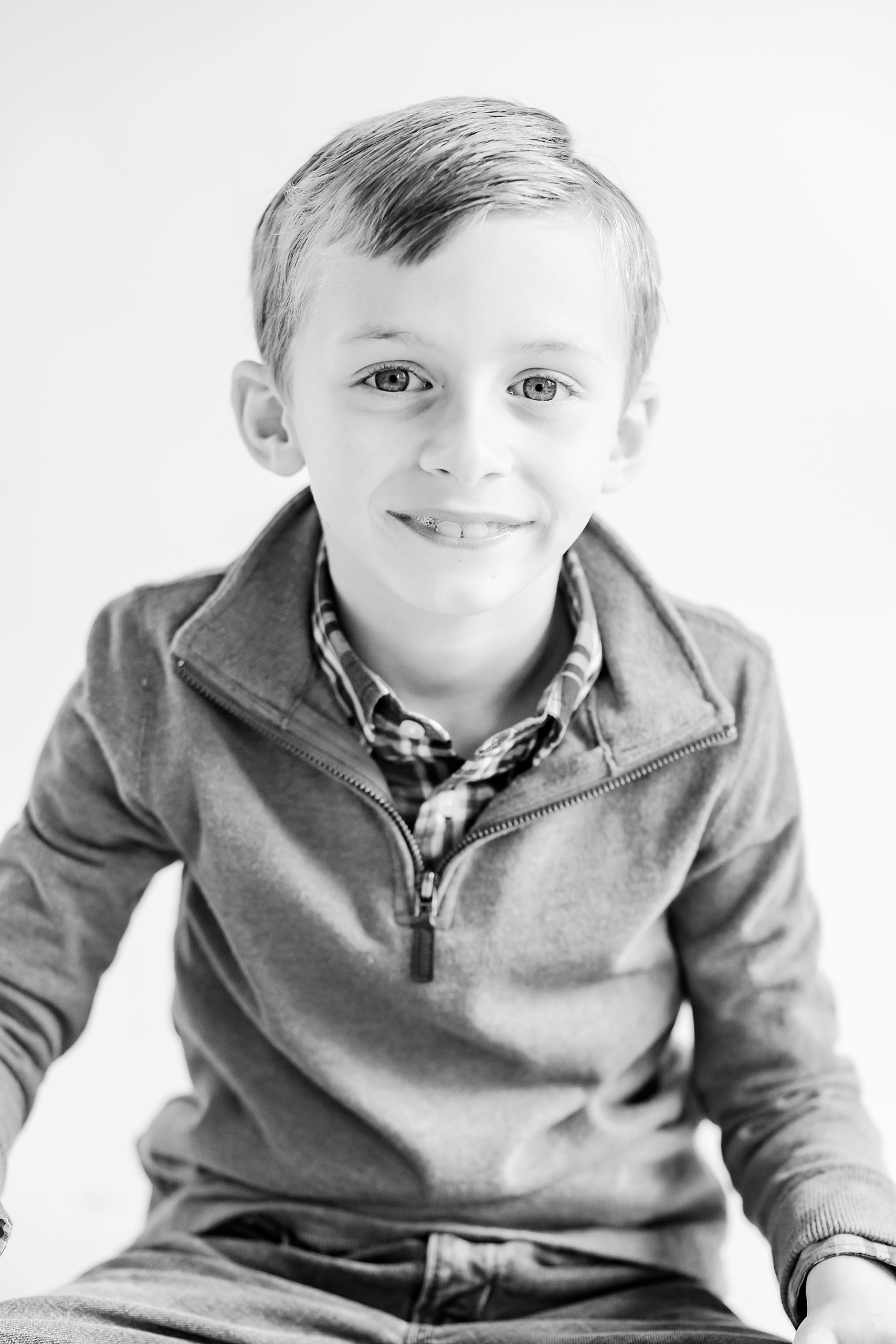 boy sits on chair in studio during studio personality portraits