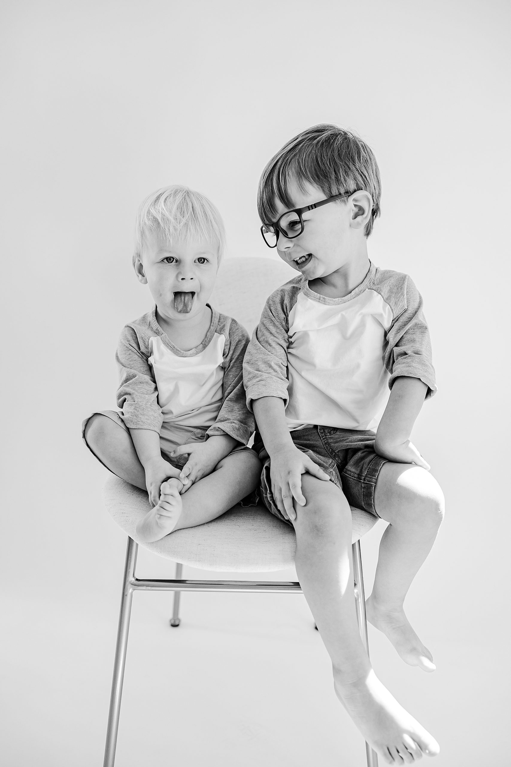 boys sit on stool during studio personality portraits