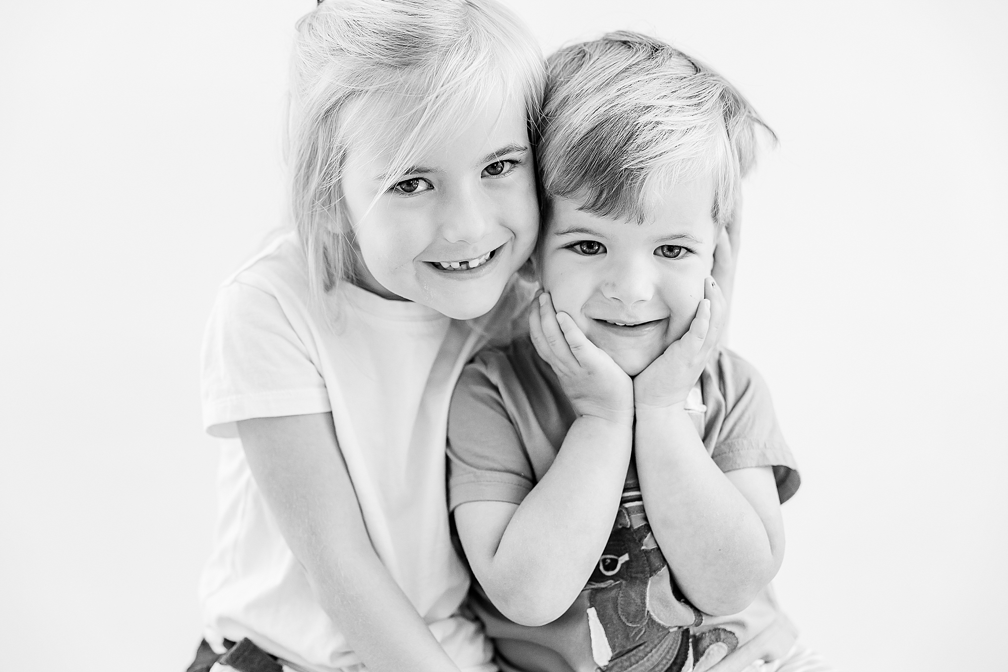 siblings hug laughing during studio personality portraits