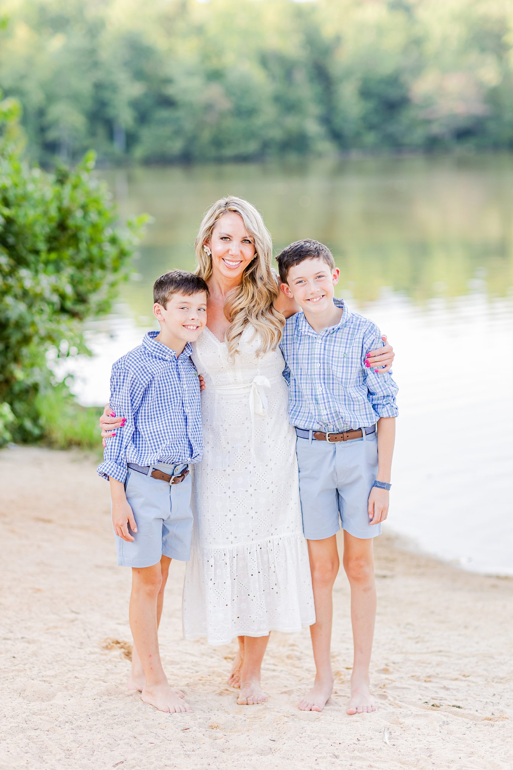 mom stands with two sons during lakefront family portraits in Charlotte 