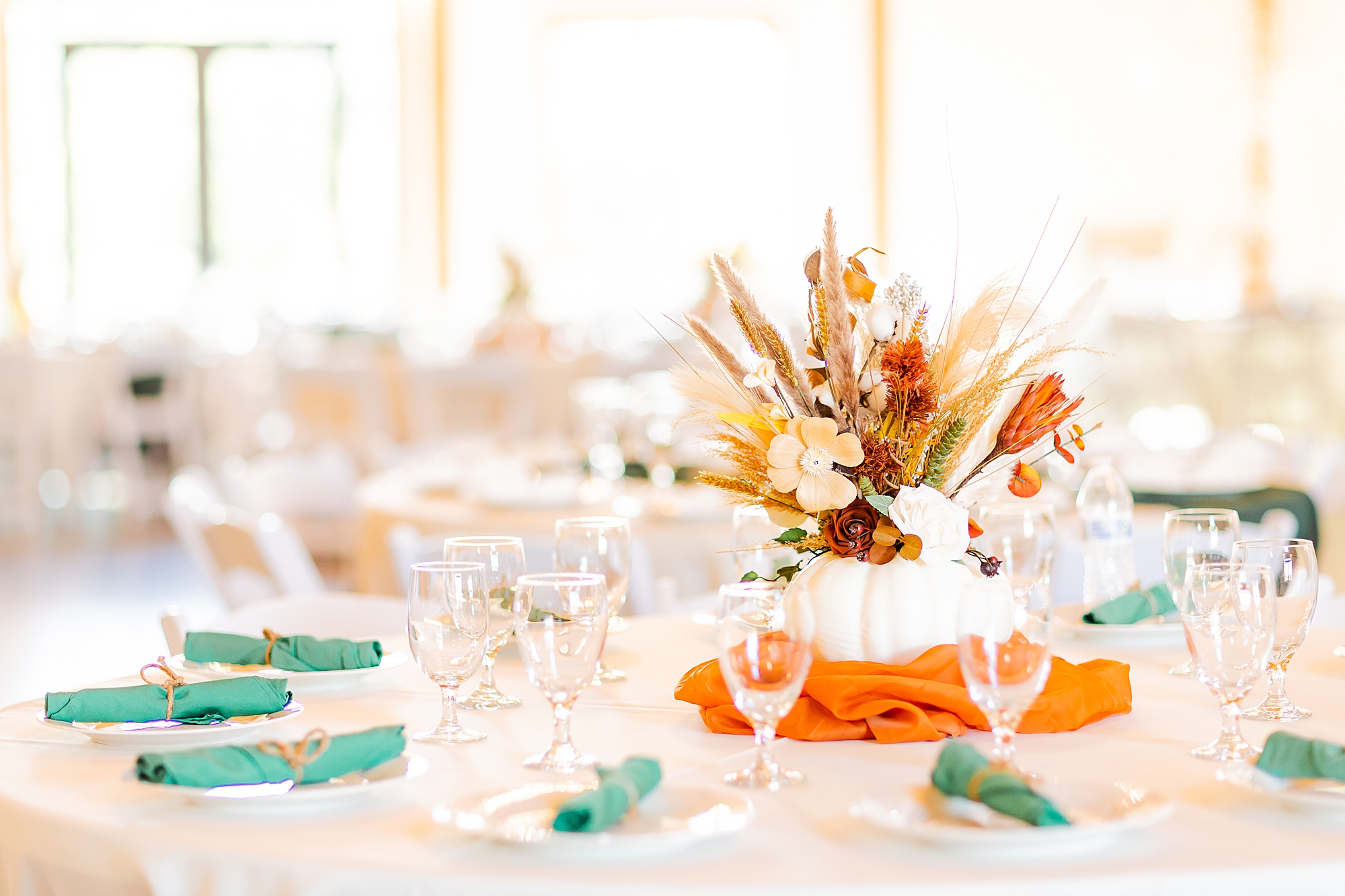 fall wedding reception with orange and teal accents 