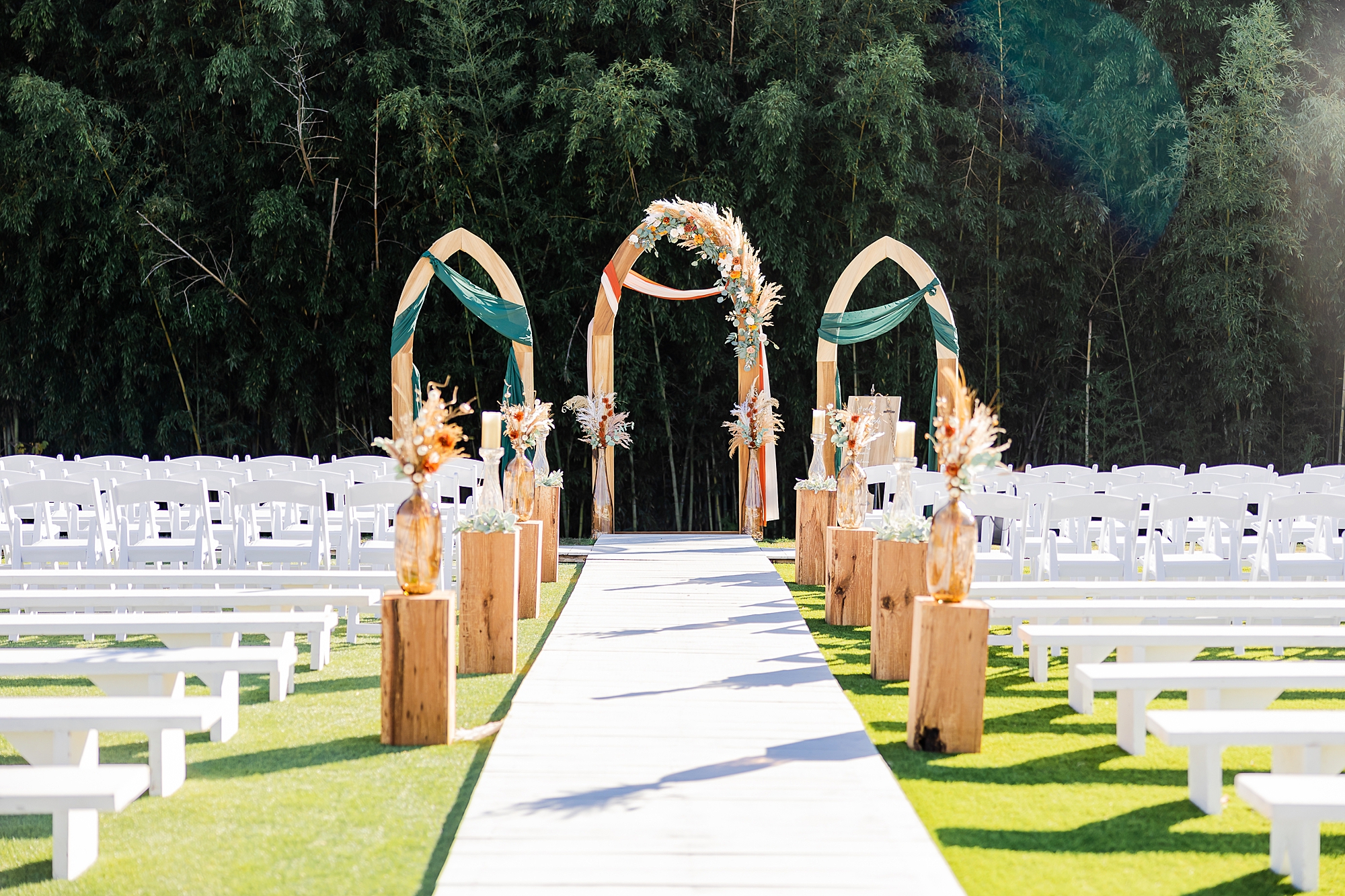 wooden arbor with green drapes at Camelot Meadows