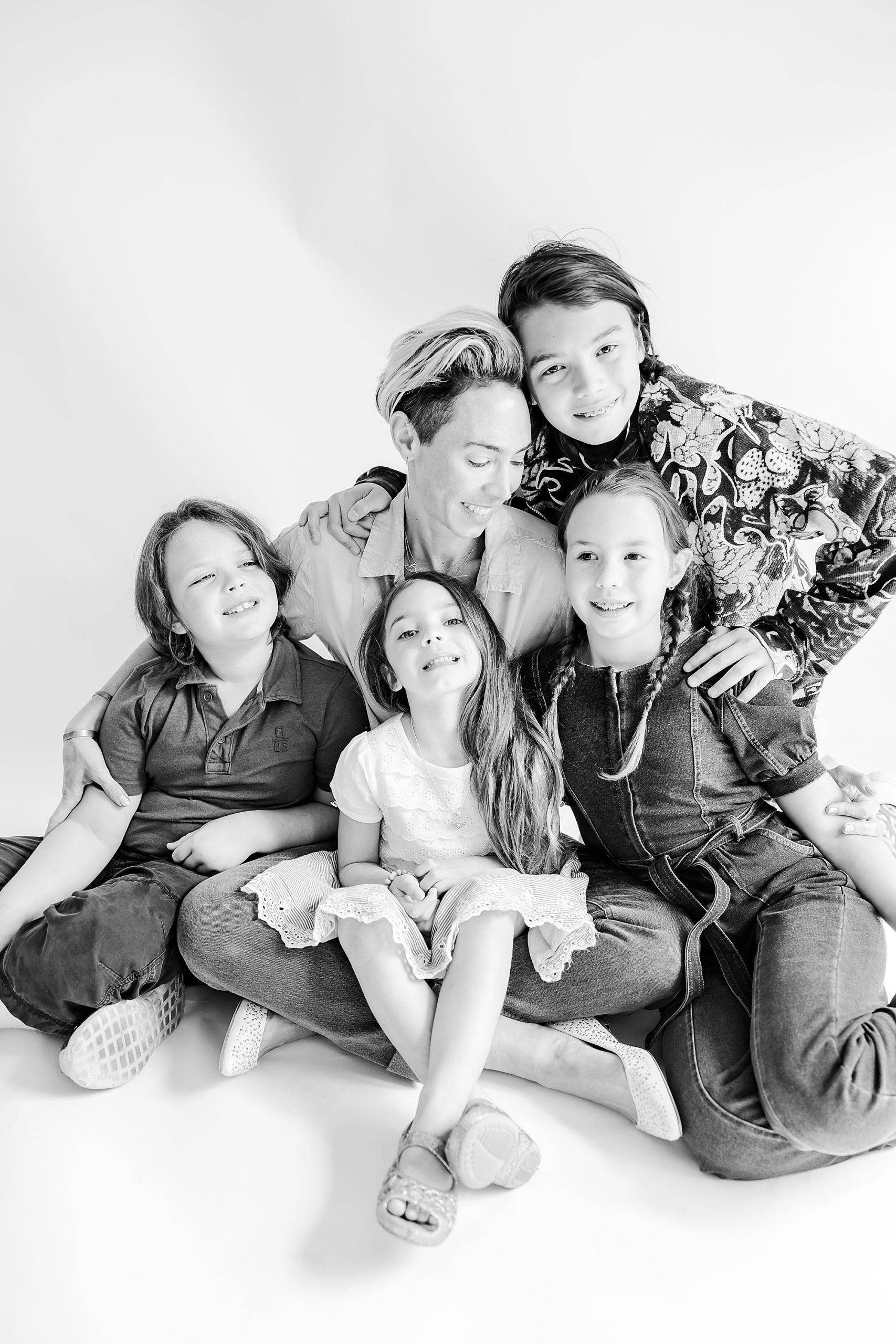 mom hugged by four children during NC portraits in studio