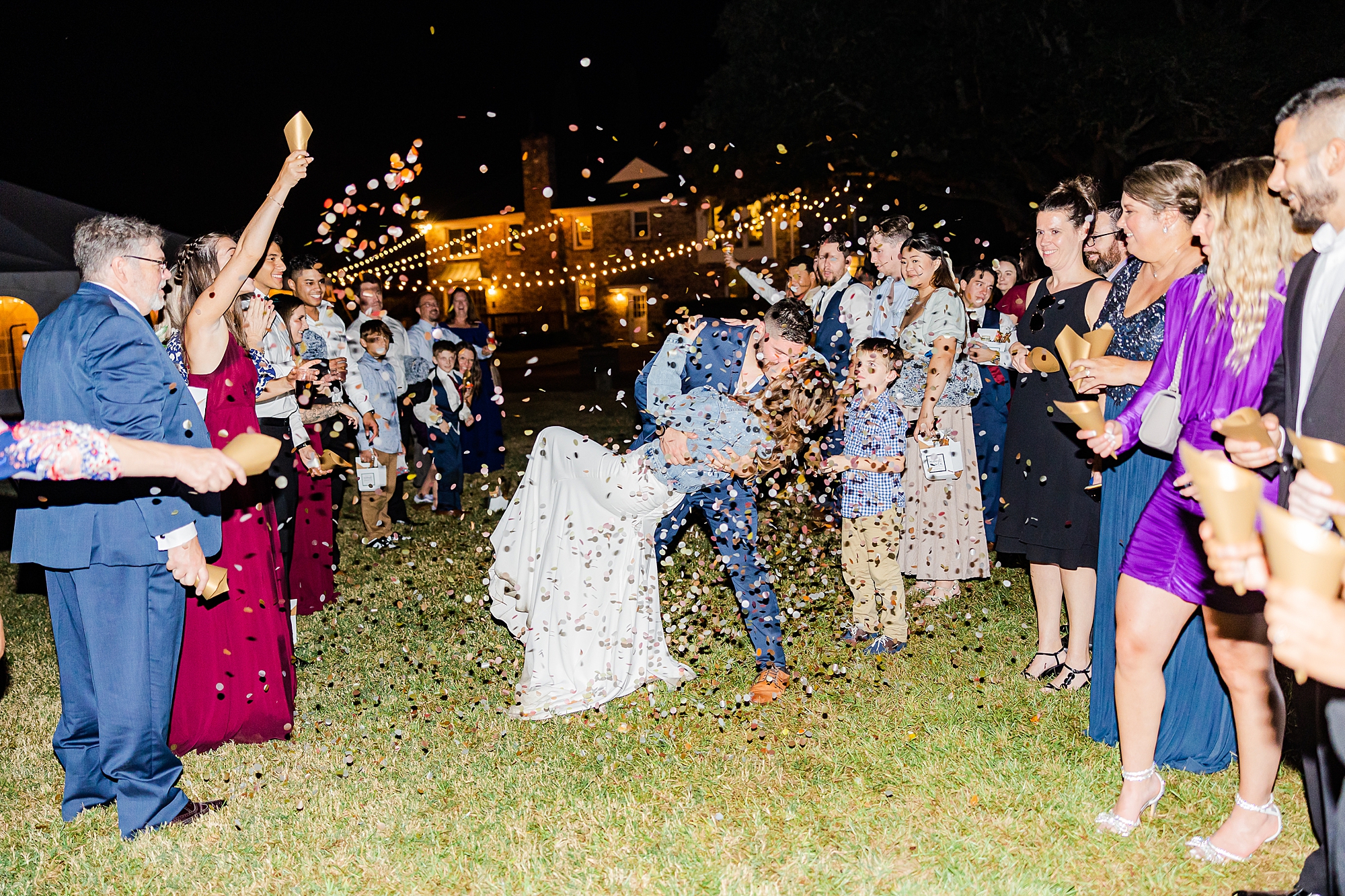couple kisses during confetti exit from SC wedding reception