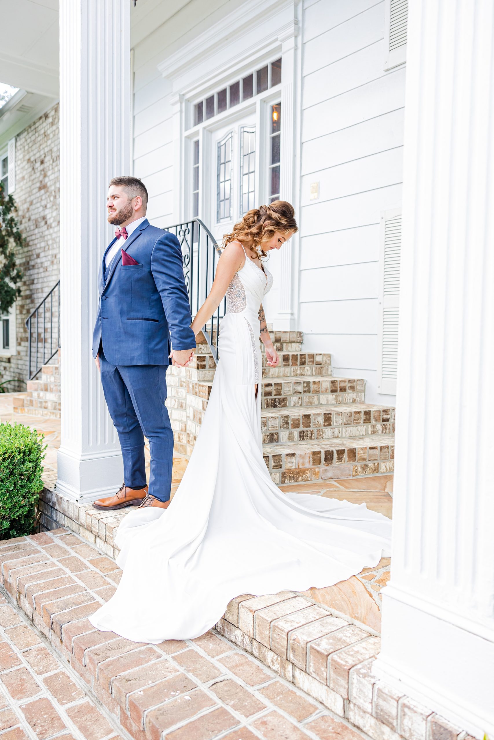 bride and groom hold hands on front porch of Island House 