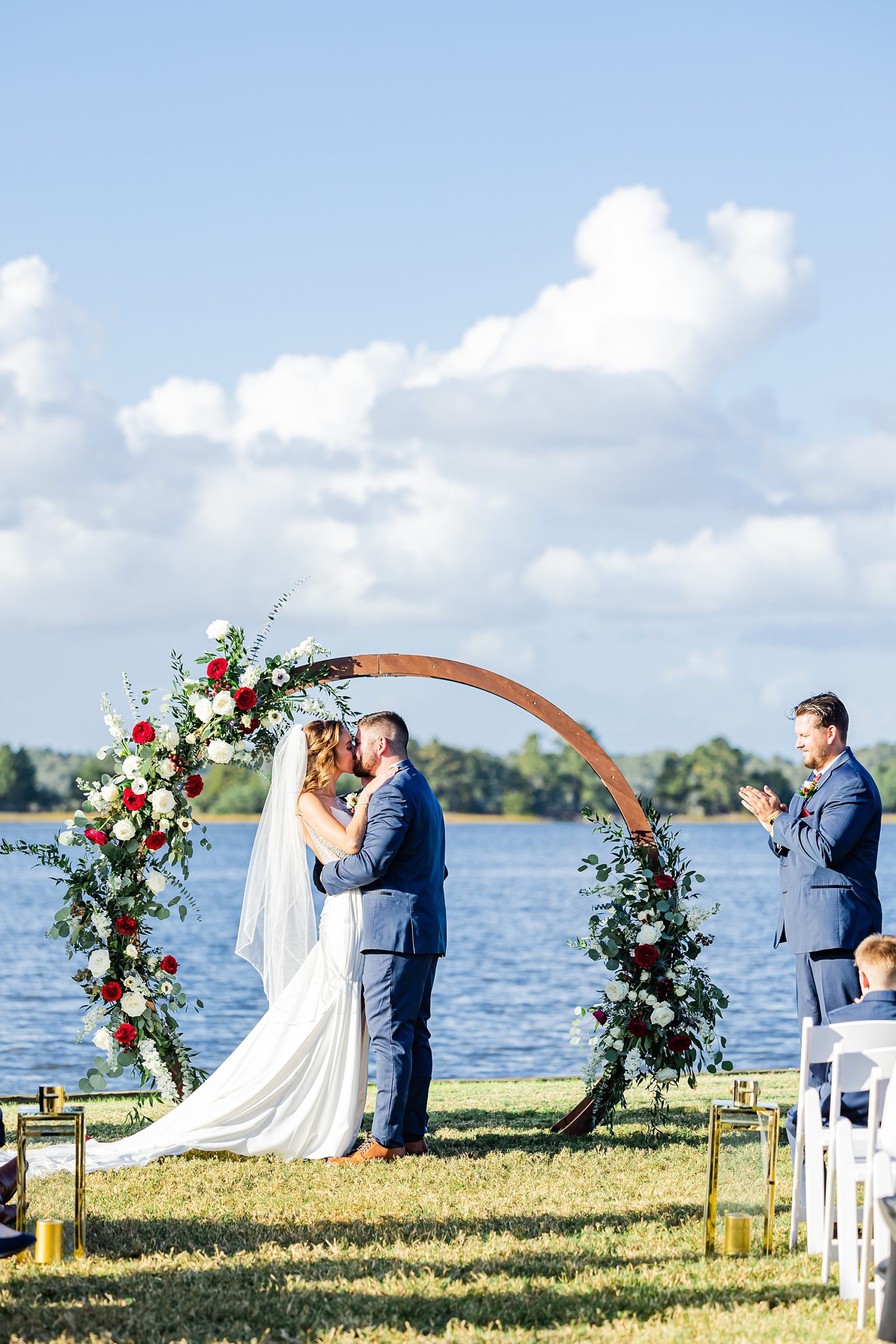 bride and groom kiss during Charleston wedding ceremony along water
