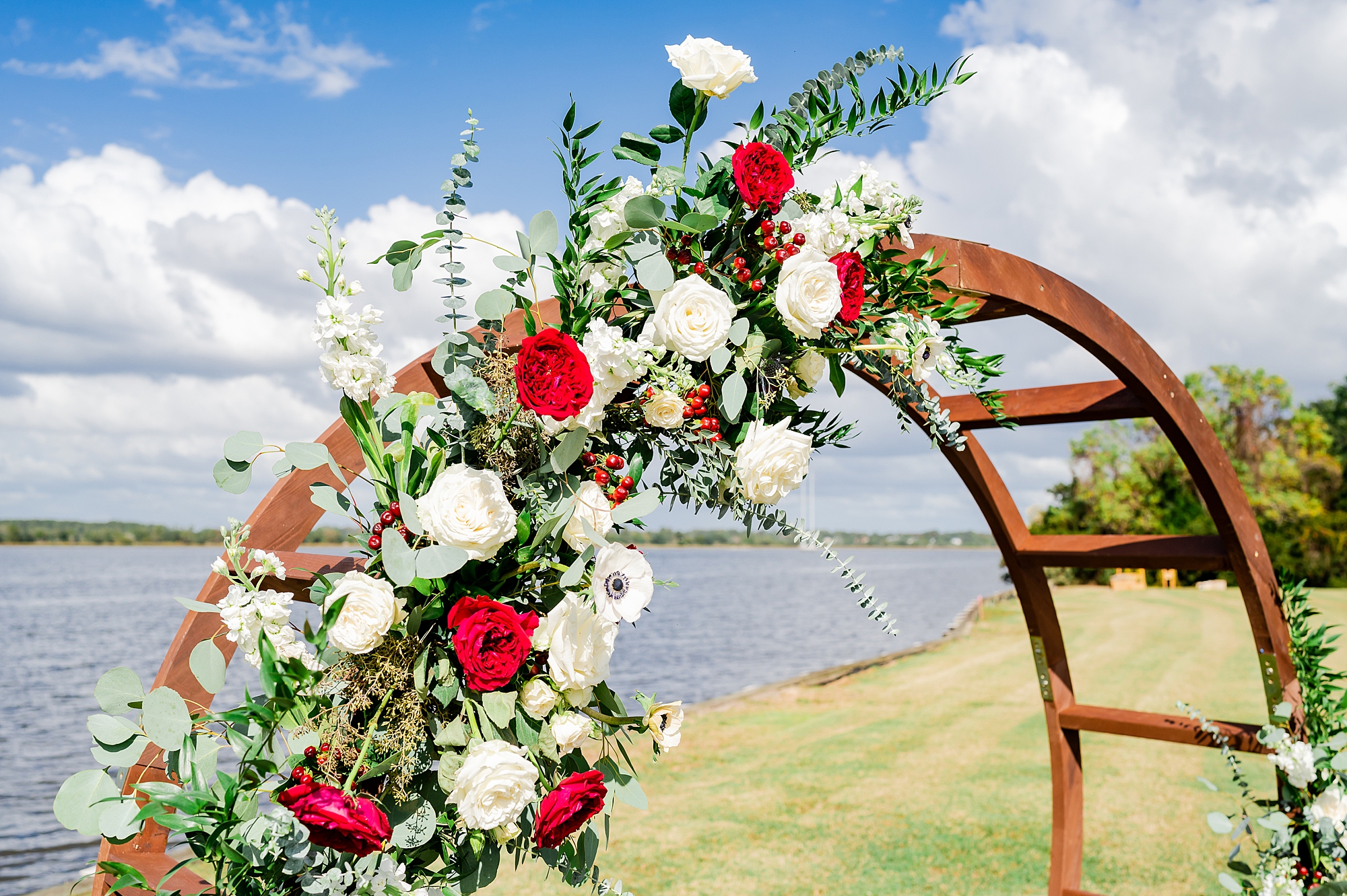 red and white roses on wooden arbor at Charleston wedding