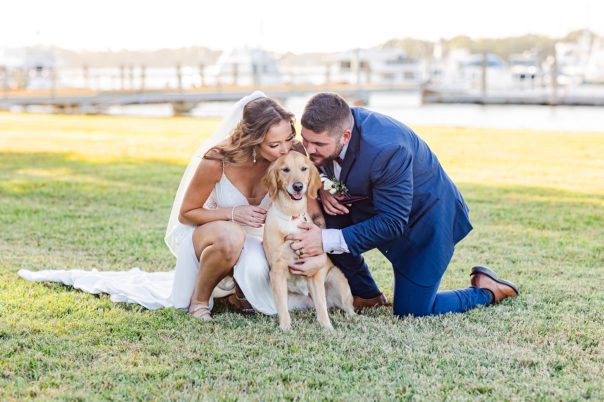 bride and groom kiss dog on wedding day 