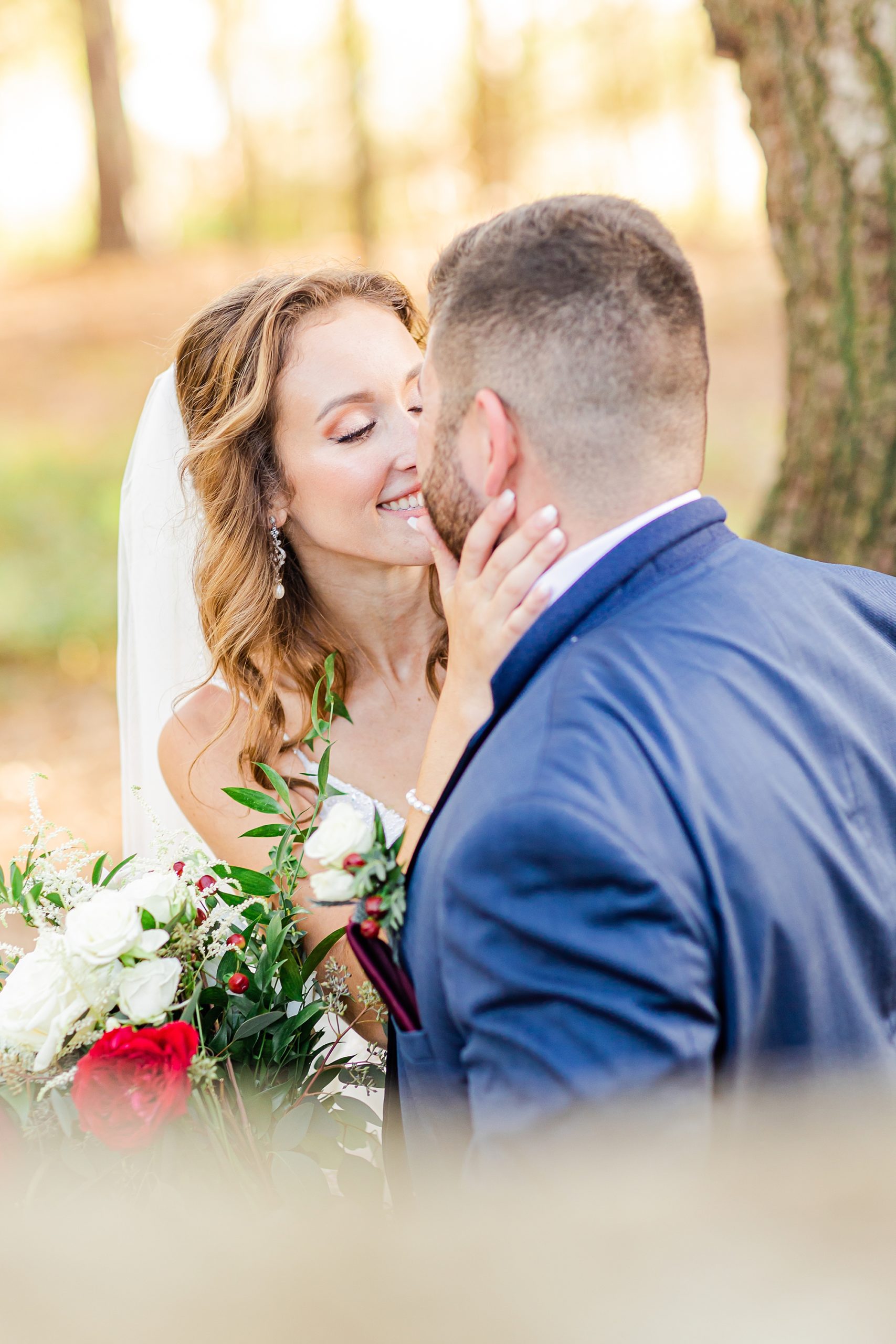 bride leans to kiss groom during portraits for Charleston wedding