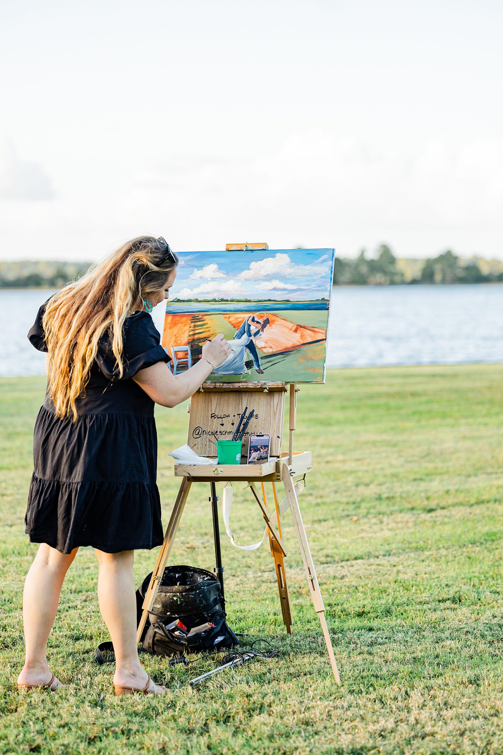 live painter works on painting outside during John's Island wedding day