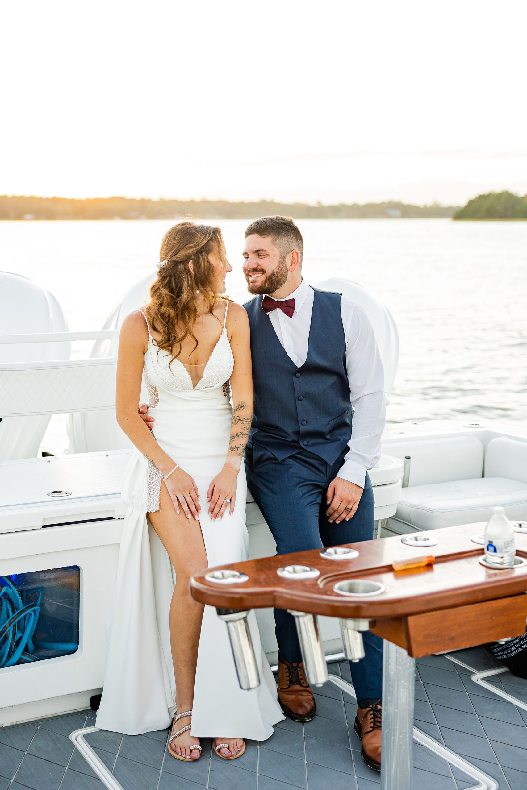 newlyweds sit on boat during John's Island wedding photos
