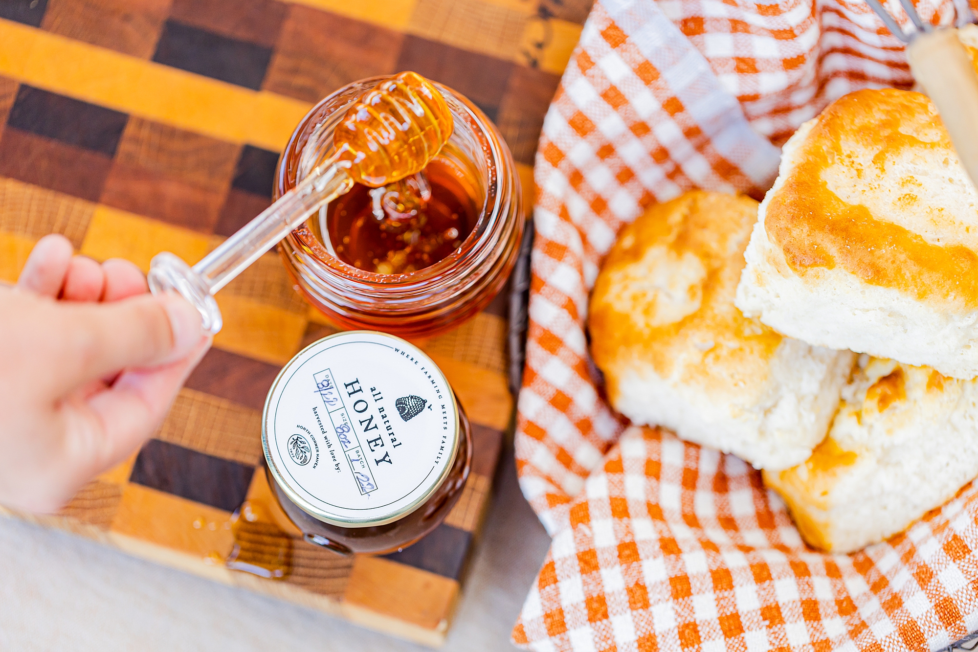 homemade biscuits sit with honey and jam for North Corner Haven product photos