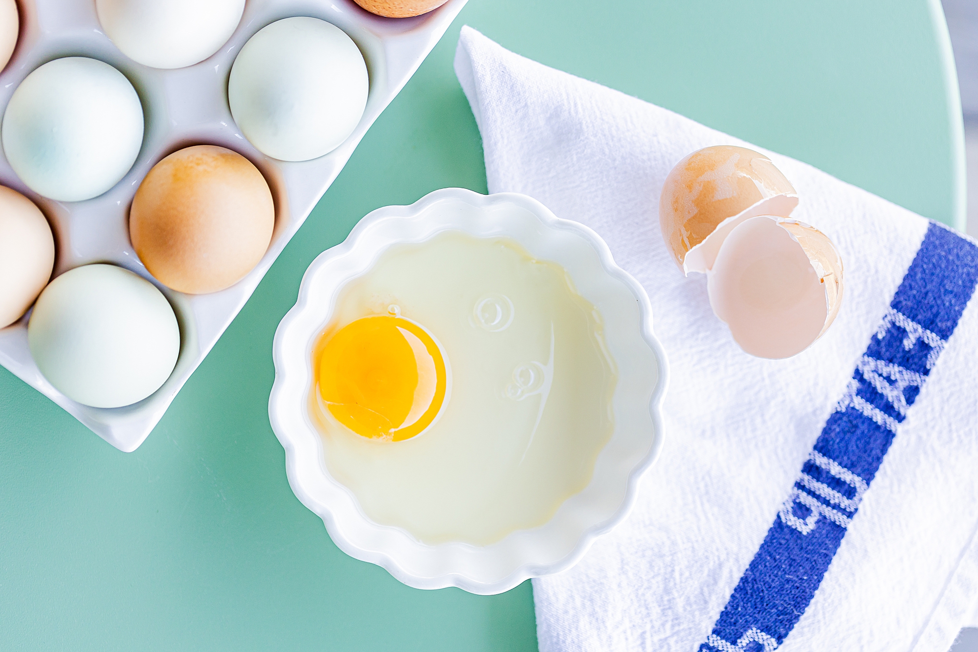 eggs sit on teal backdrop during North Corner Haven product photos