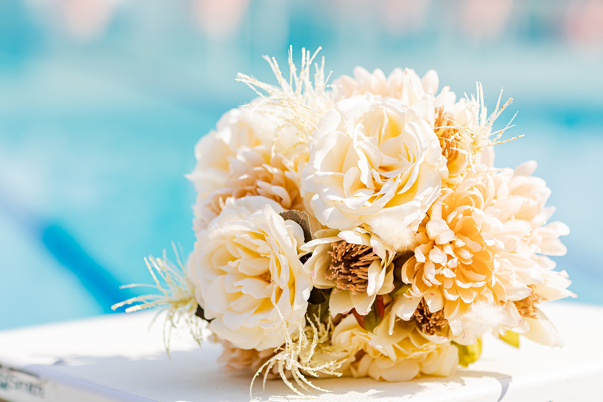 bouquet of pale roses and yellow flowers on diving board at Starclaire Recreation Club