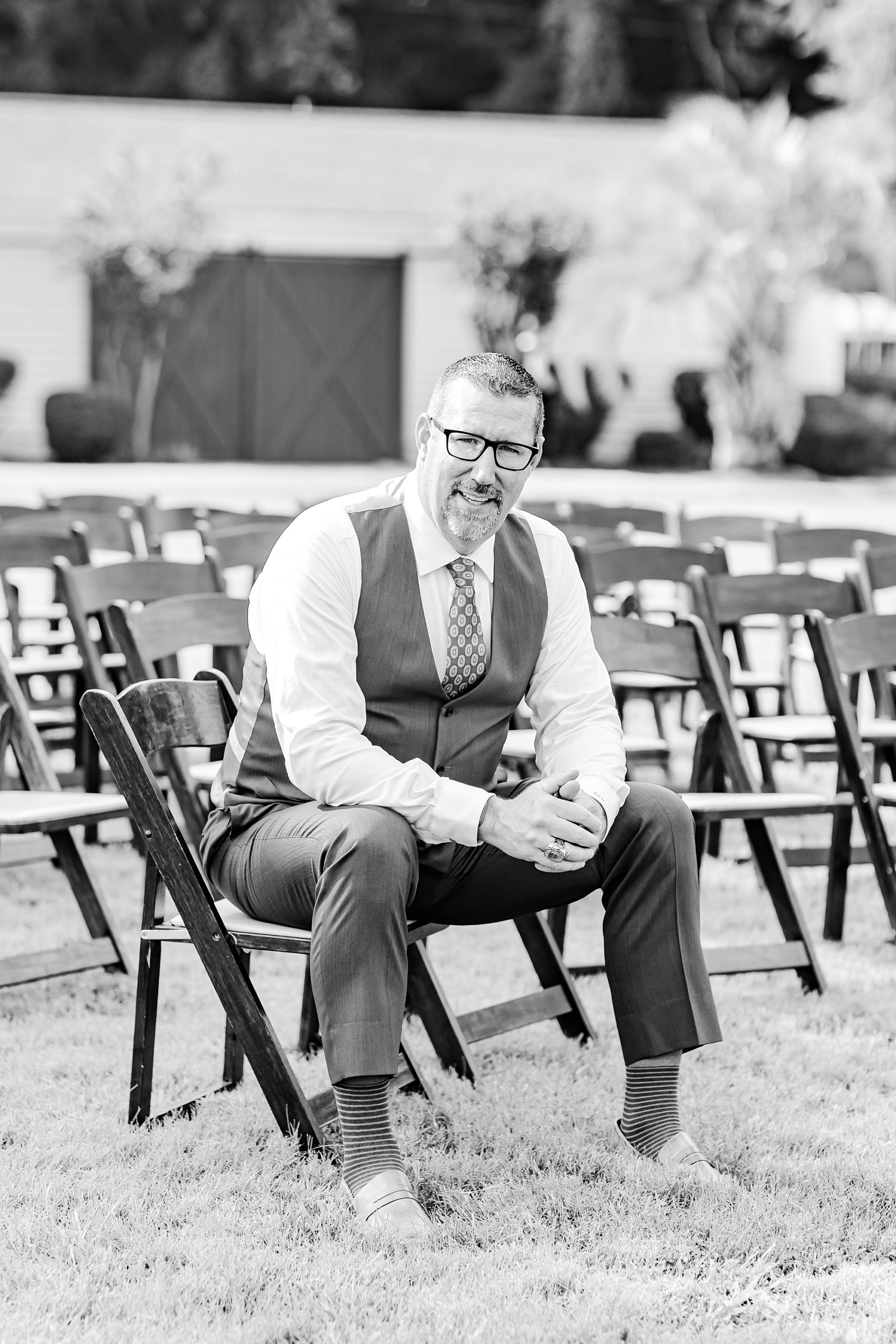 groom sits in folding chair at Starclaire Recreation Club