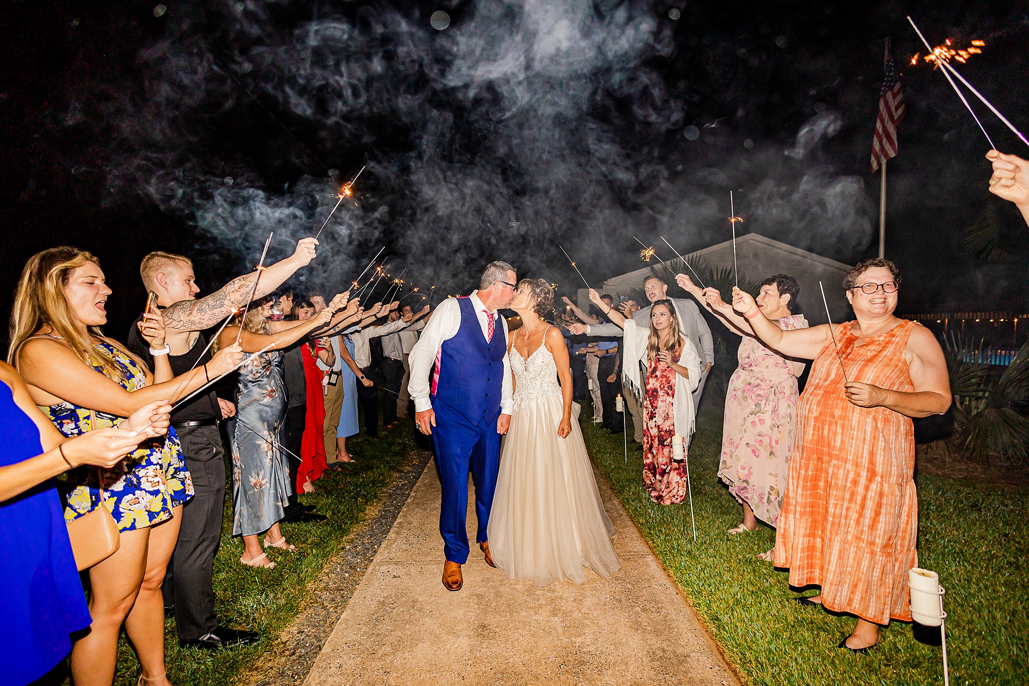 newlyweds kiss during sparkler exit from Starclaire Recreation Club