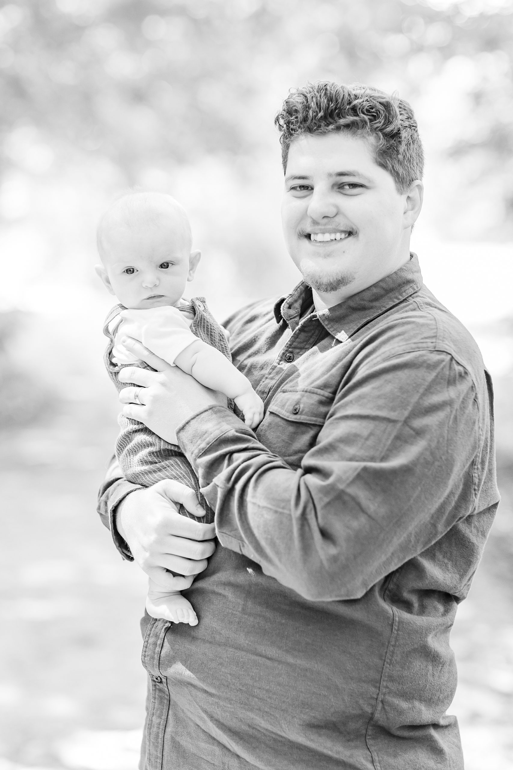 dad hugs 6 month old son during family portraits 