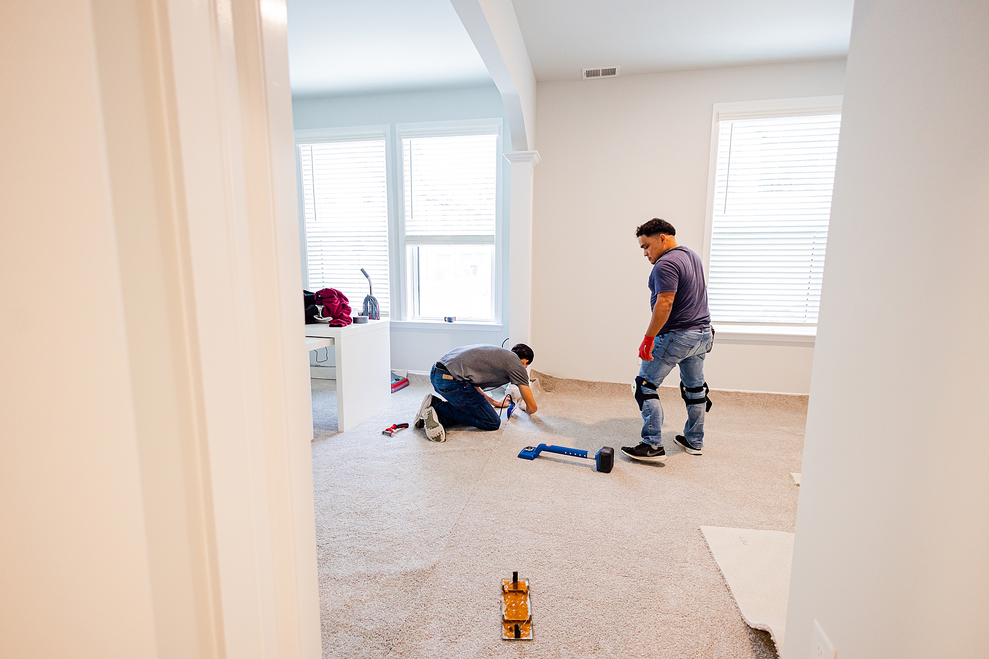 contractors work on flooring during renovations with Turn Key Solutions
