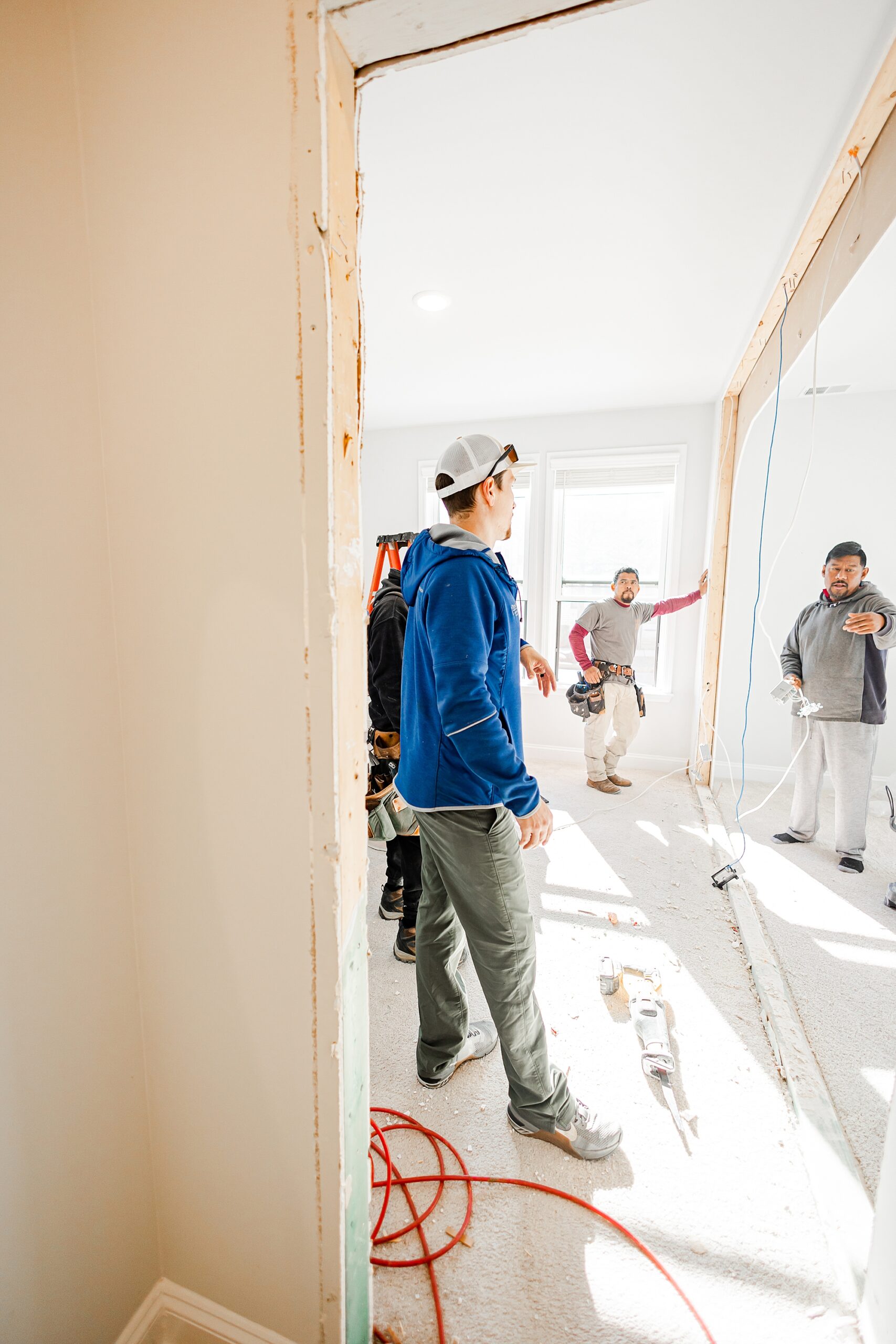 contractors look at drywall and open wall during renovations with Turn Key Solutions