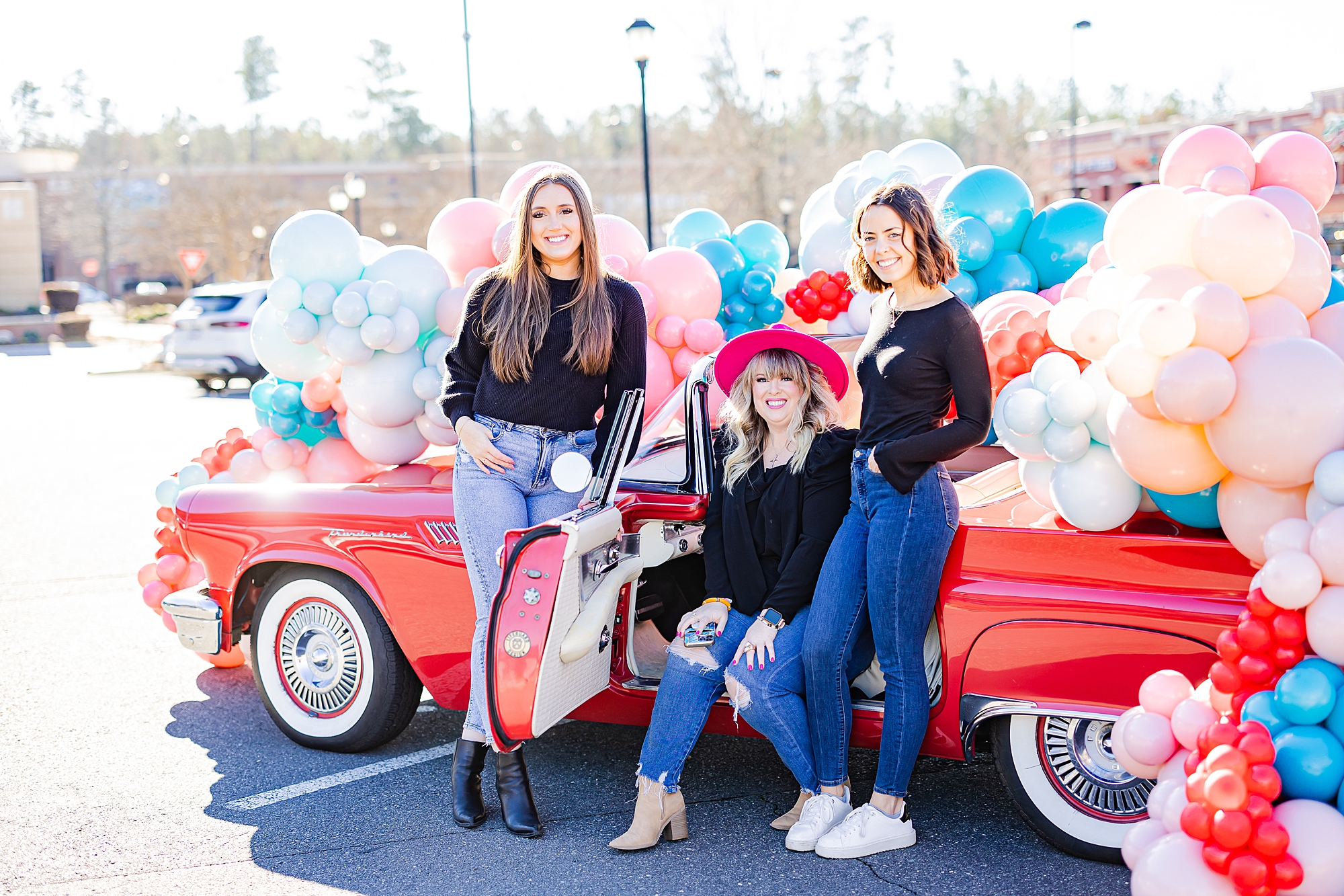 owners of Sips and Dips pose with red Thunderbird during Valentine’s Day photos