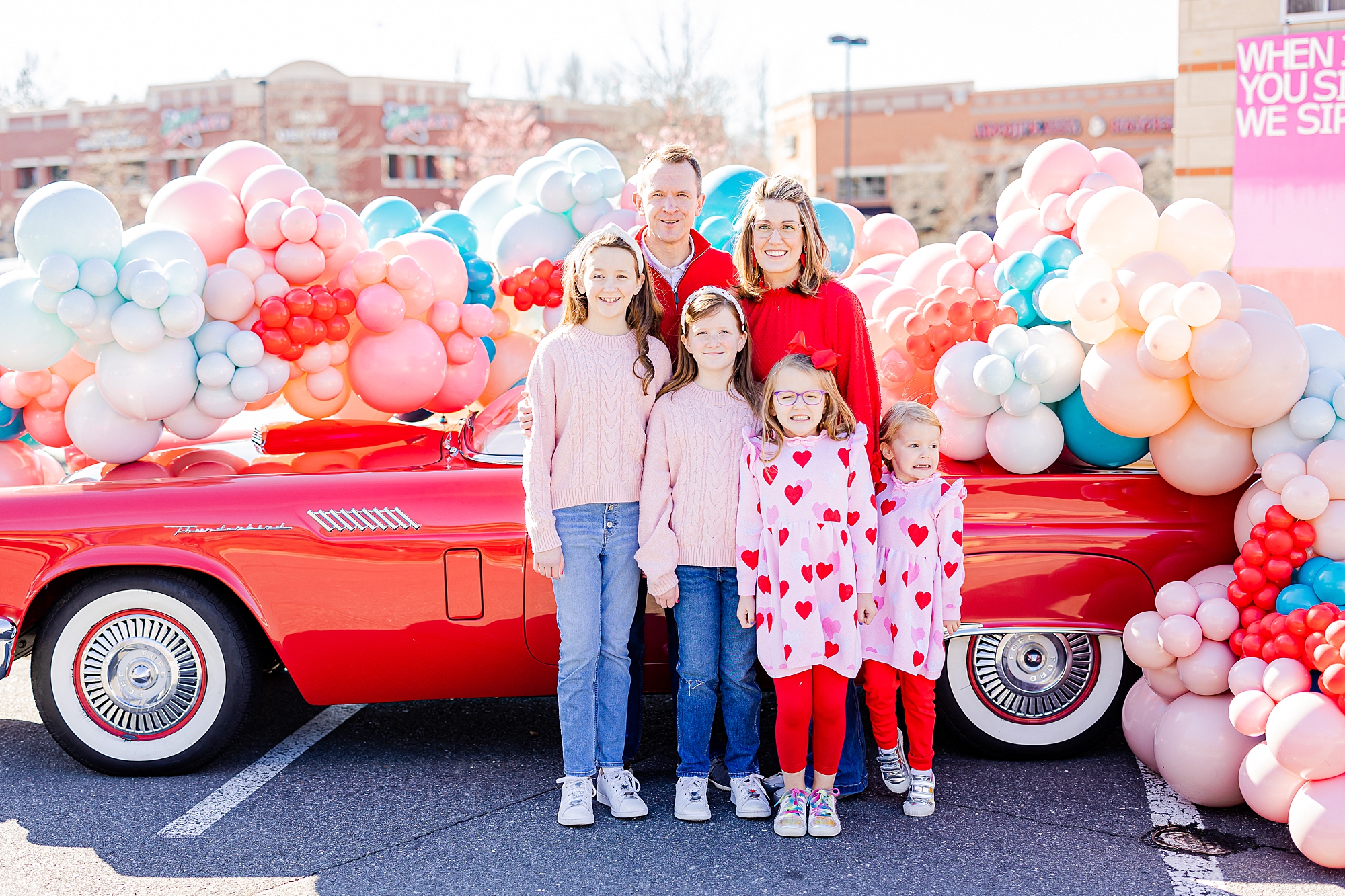 parents pose with four children during Valentine’s Day Thunderbird Photos